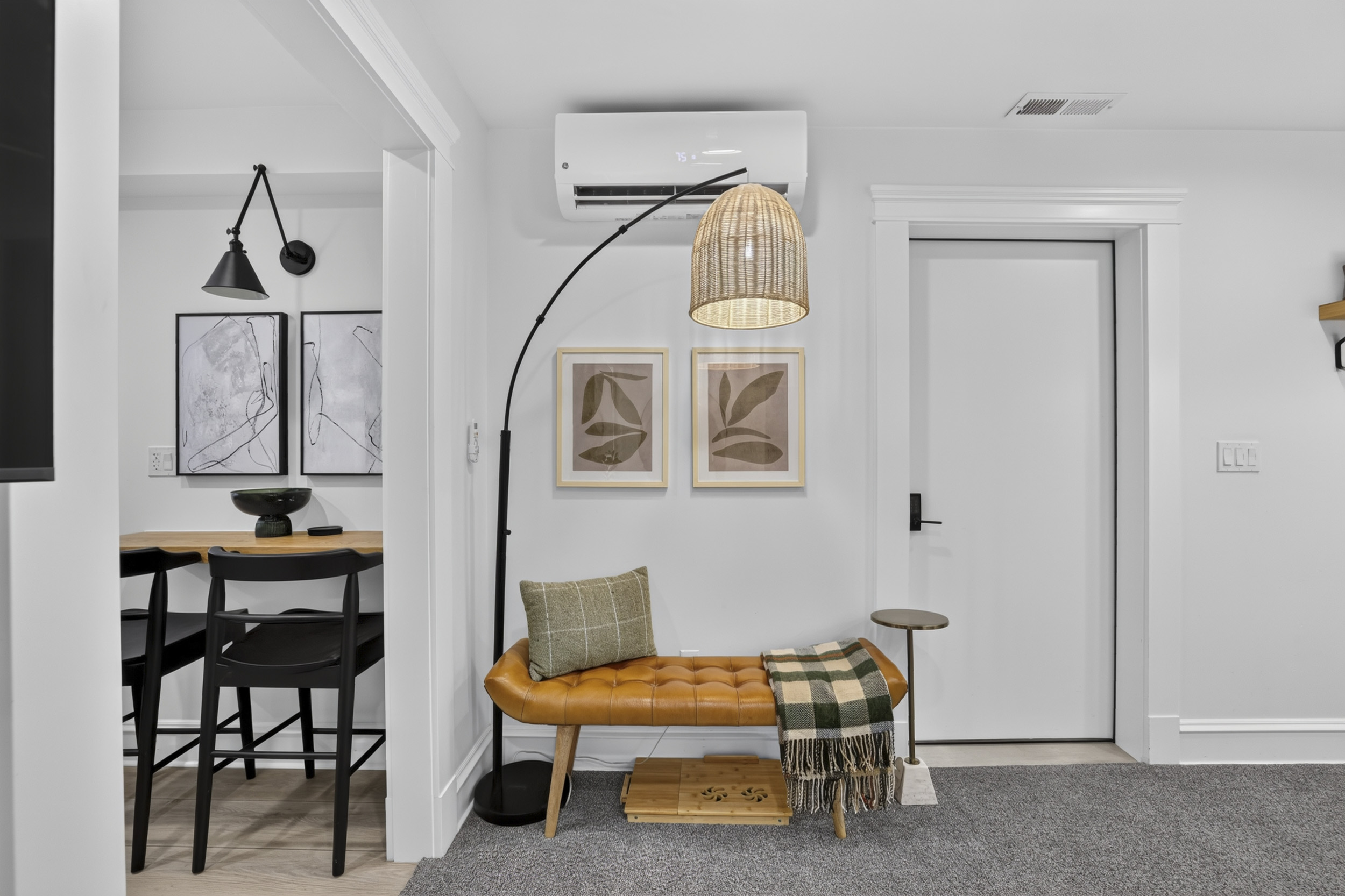 Stylish entry nook with leather bench, cozy accents, and modern decor