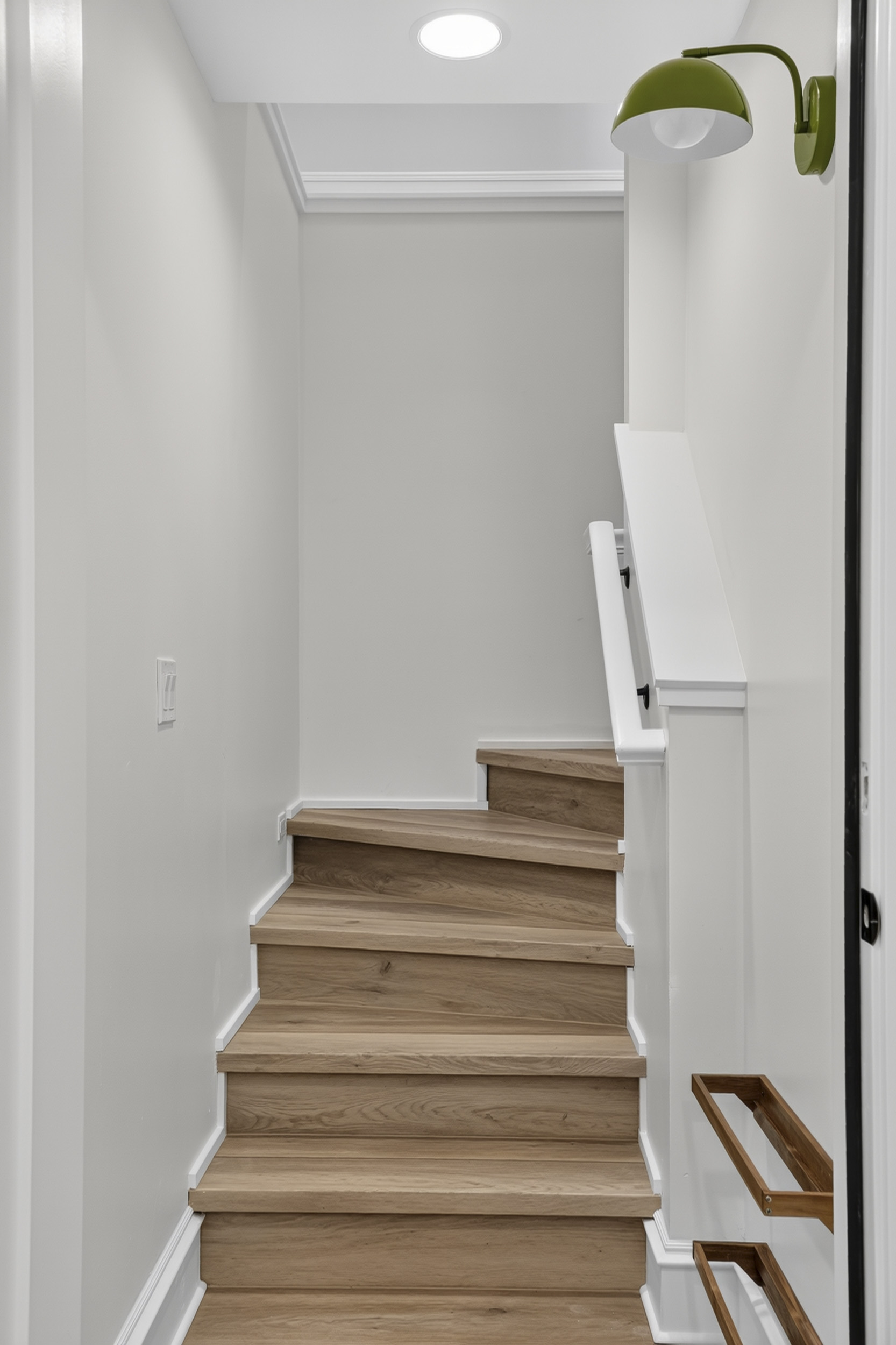 Bright modern staircase with warm wood steps and stylish designer lighting