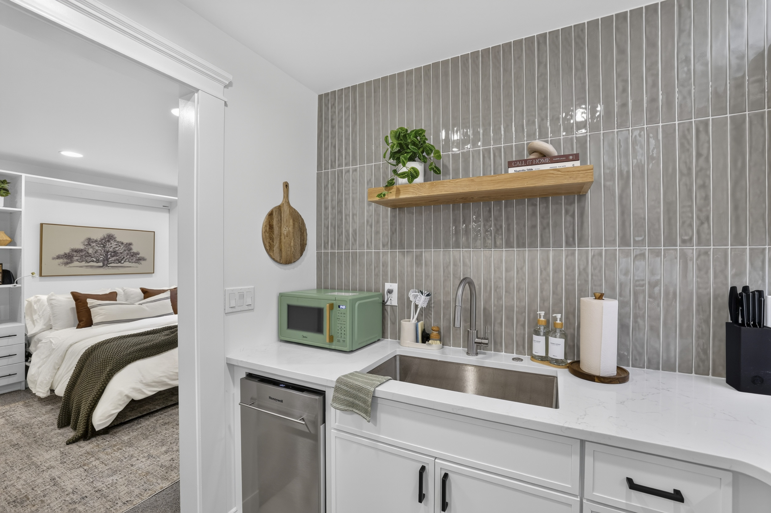 Modern kitchenette with sleek finishes and easy access to the cozy bedroom