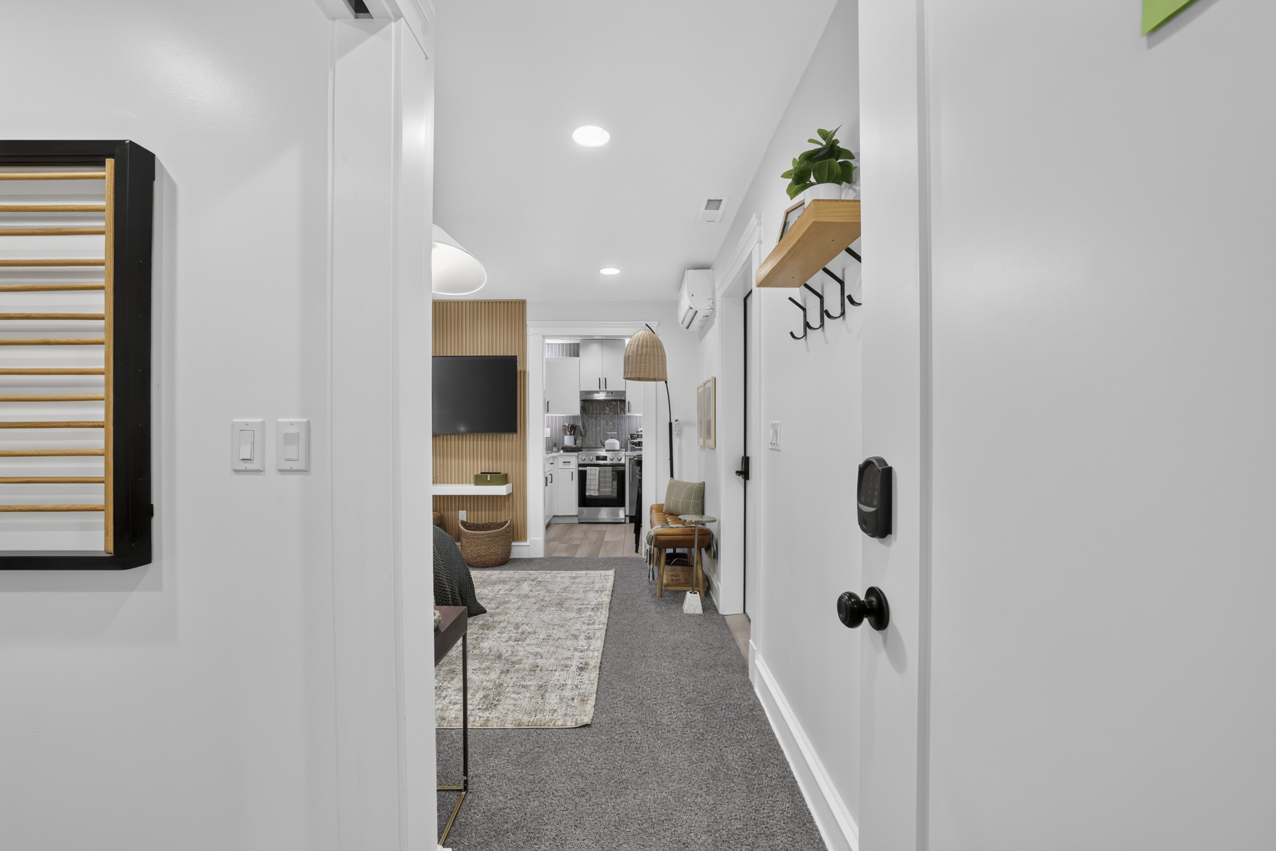 Bright modern entryway with cozy living area and stylish design touches