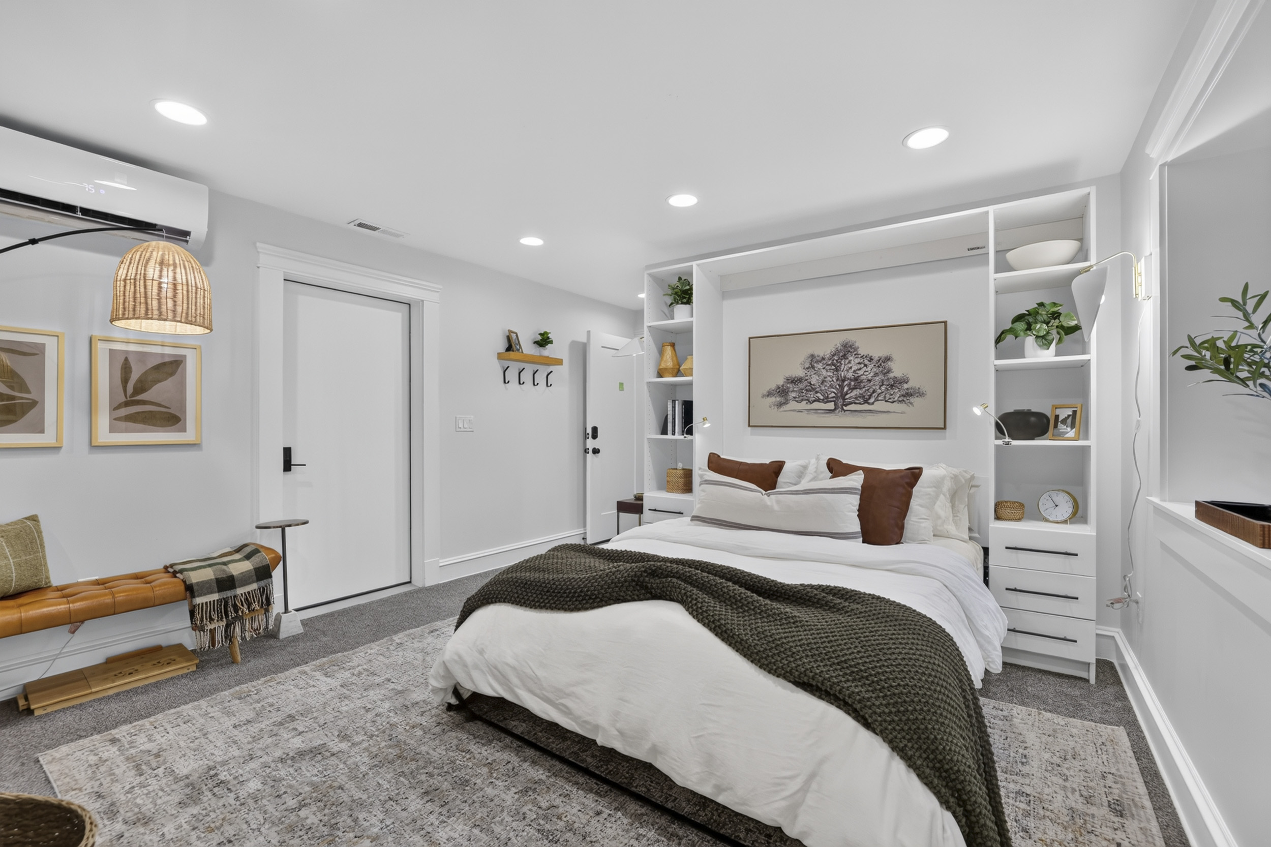 Bright, cozy bedroom with built-ins, plush bedding, and modern comforts