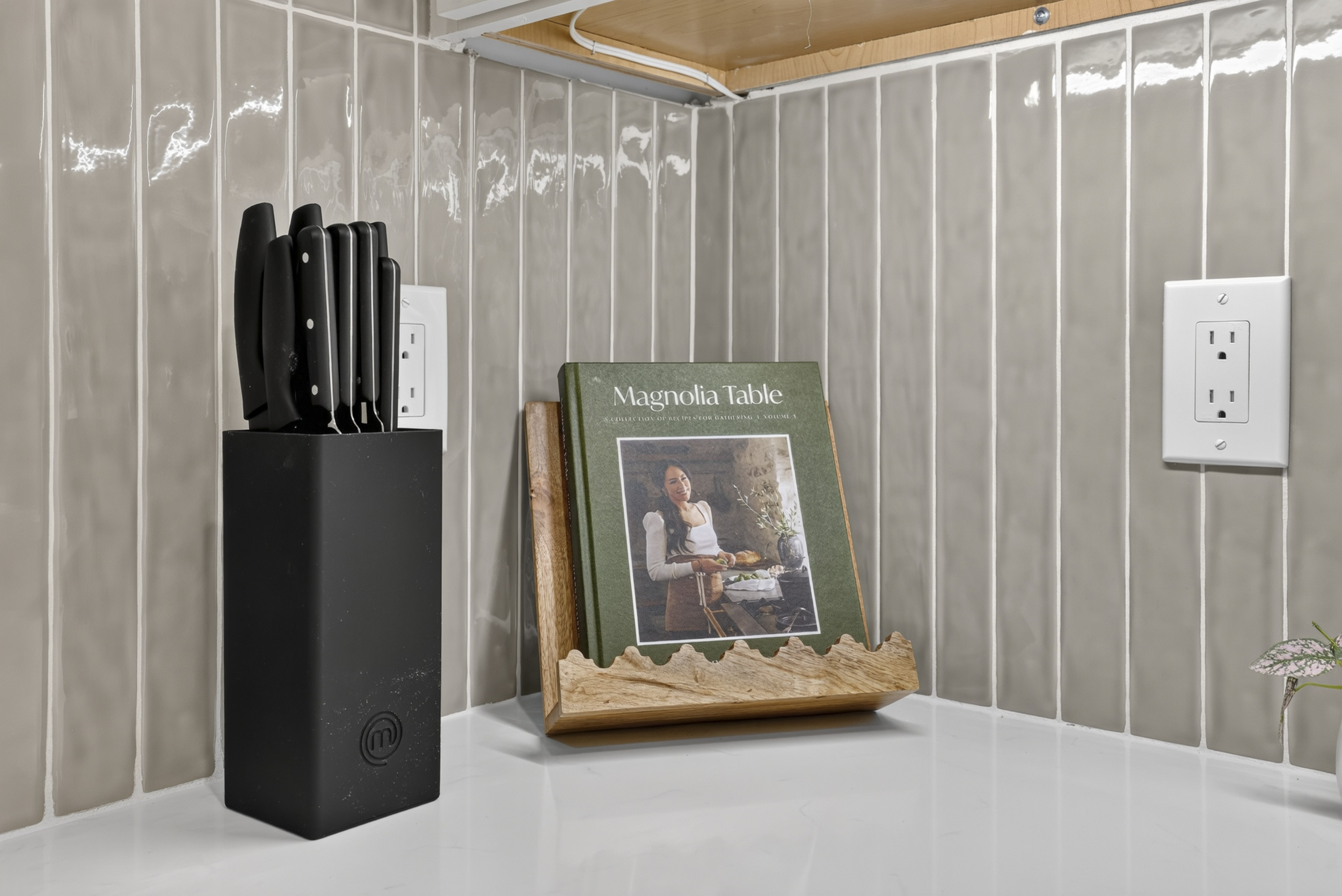 Stylish, well-equipped kitchen details with sleek tile backsplash