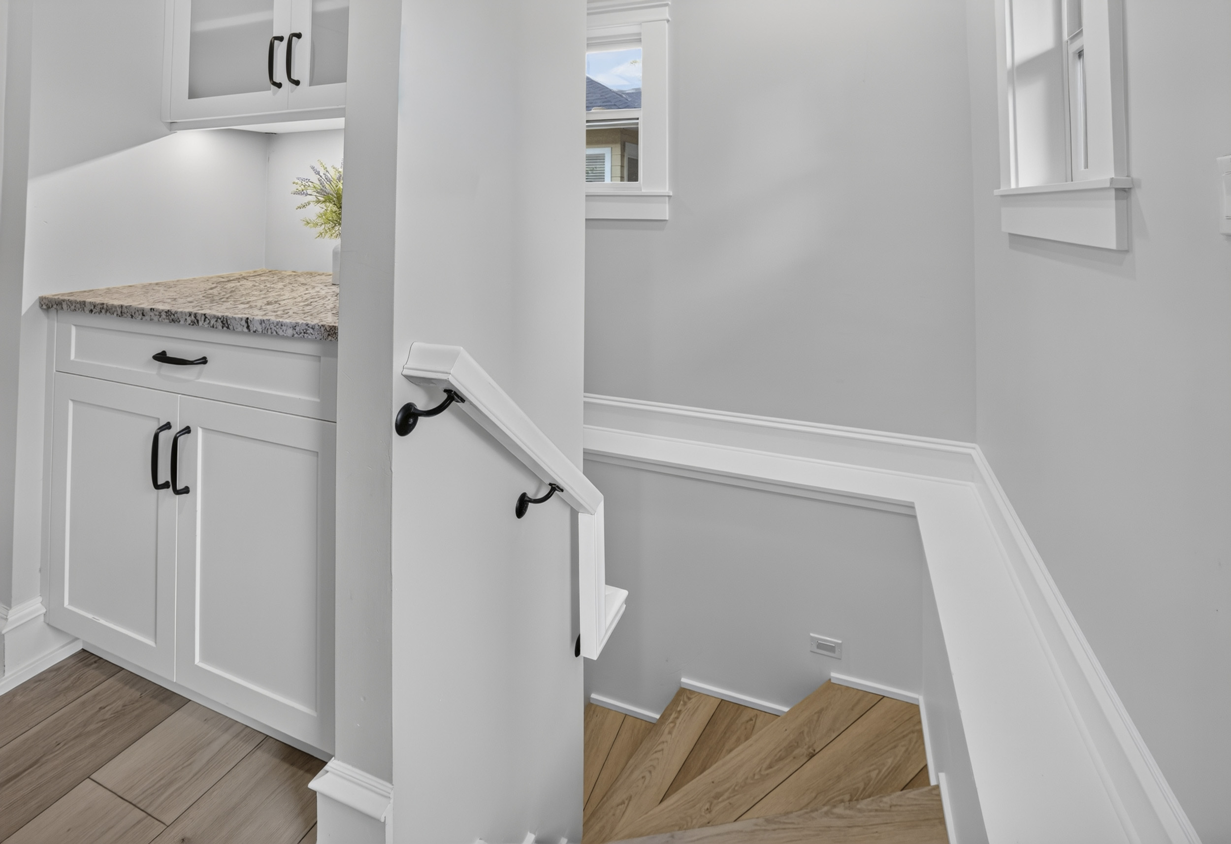 Bright stair landing with built-in storage and modern finishes
