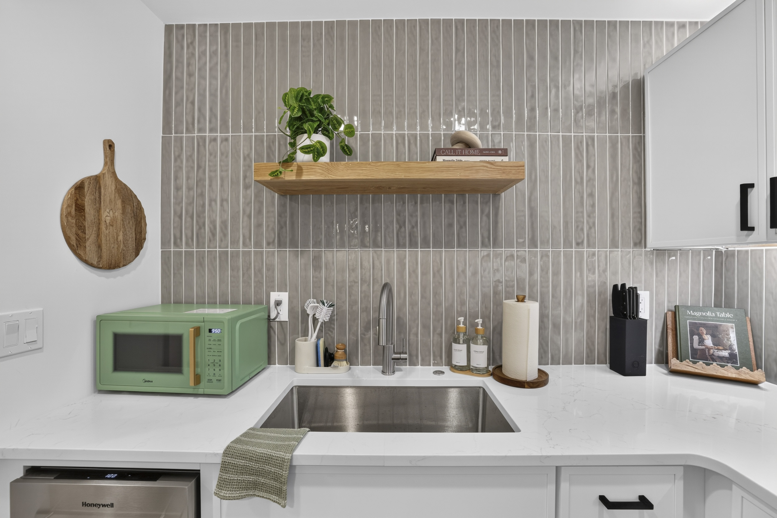 Modern kitchenette with sleek finishes, mini fridge, and stylish decor