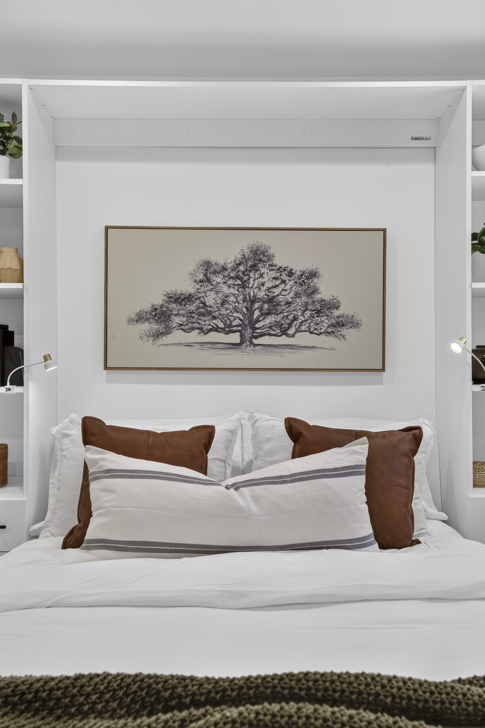 Cozy, stylish bedroom with built-ins and elegant tree artwork
