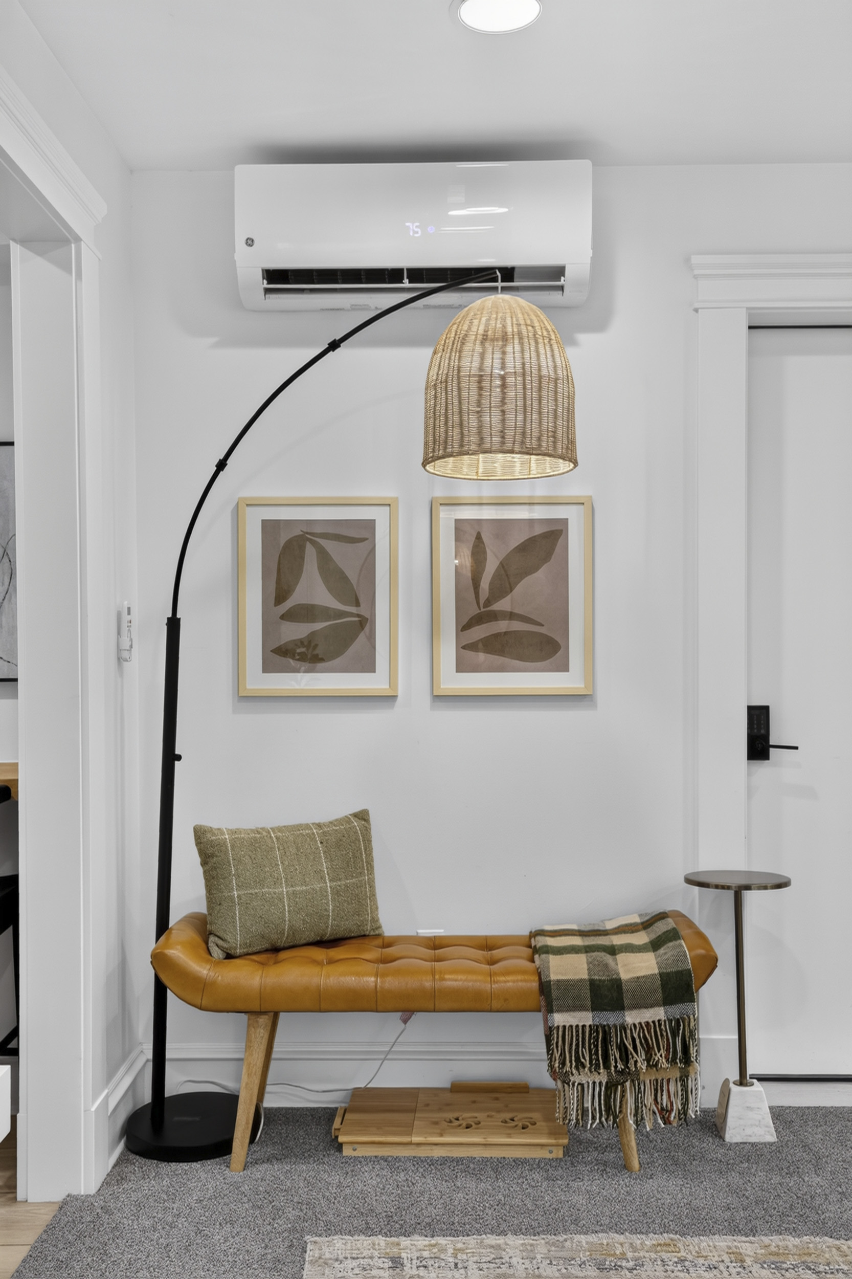 Welcoming entry nook with cozy seating, stylish decor, and AC comfort