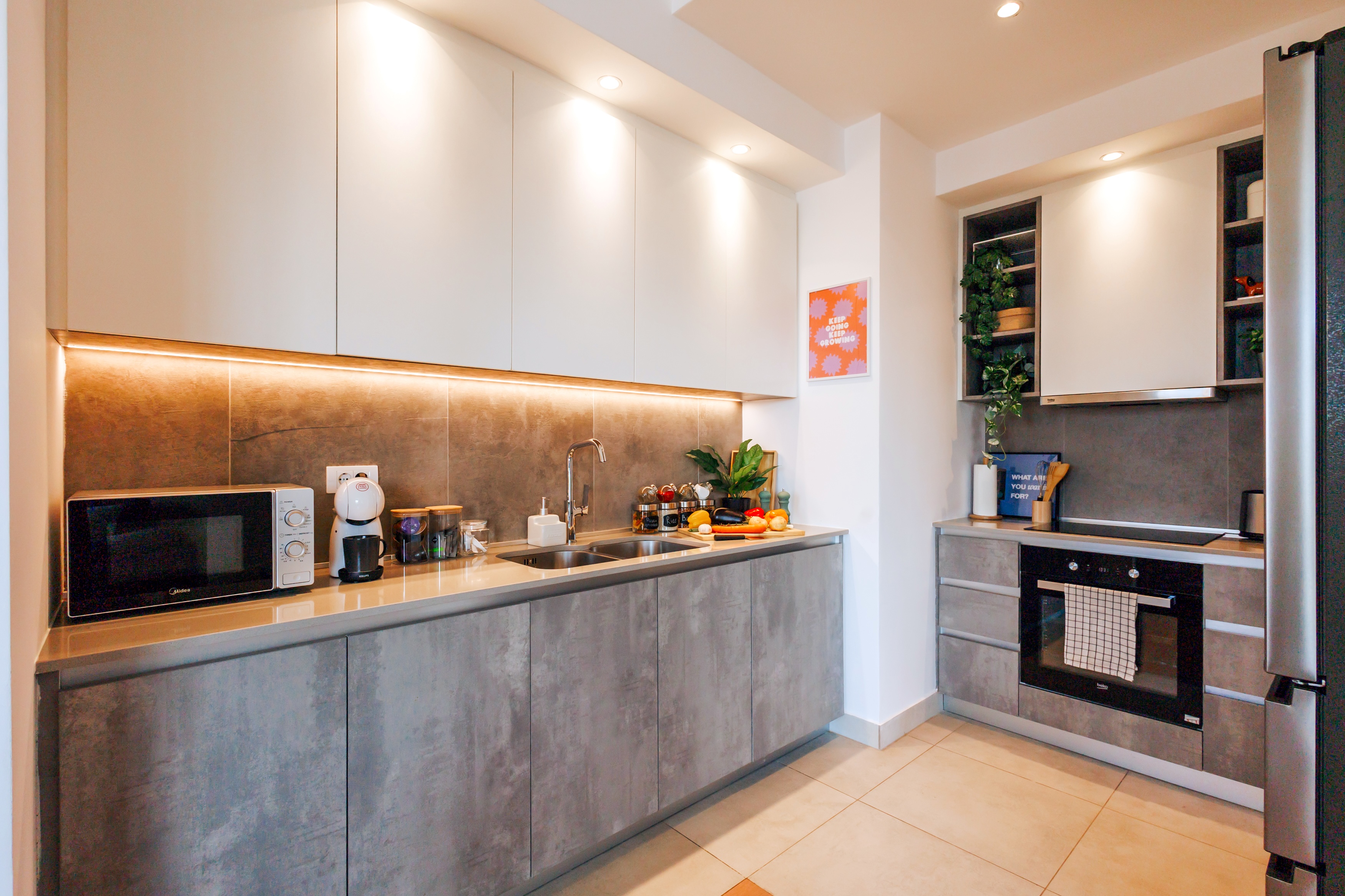 Modern, fully equipped kitchen with warm lighting and sleek finishes