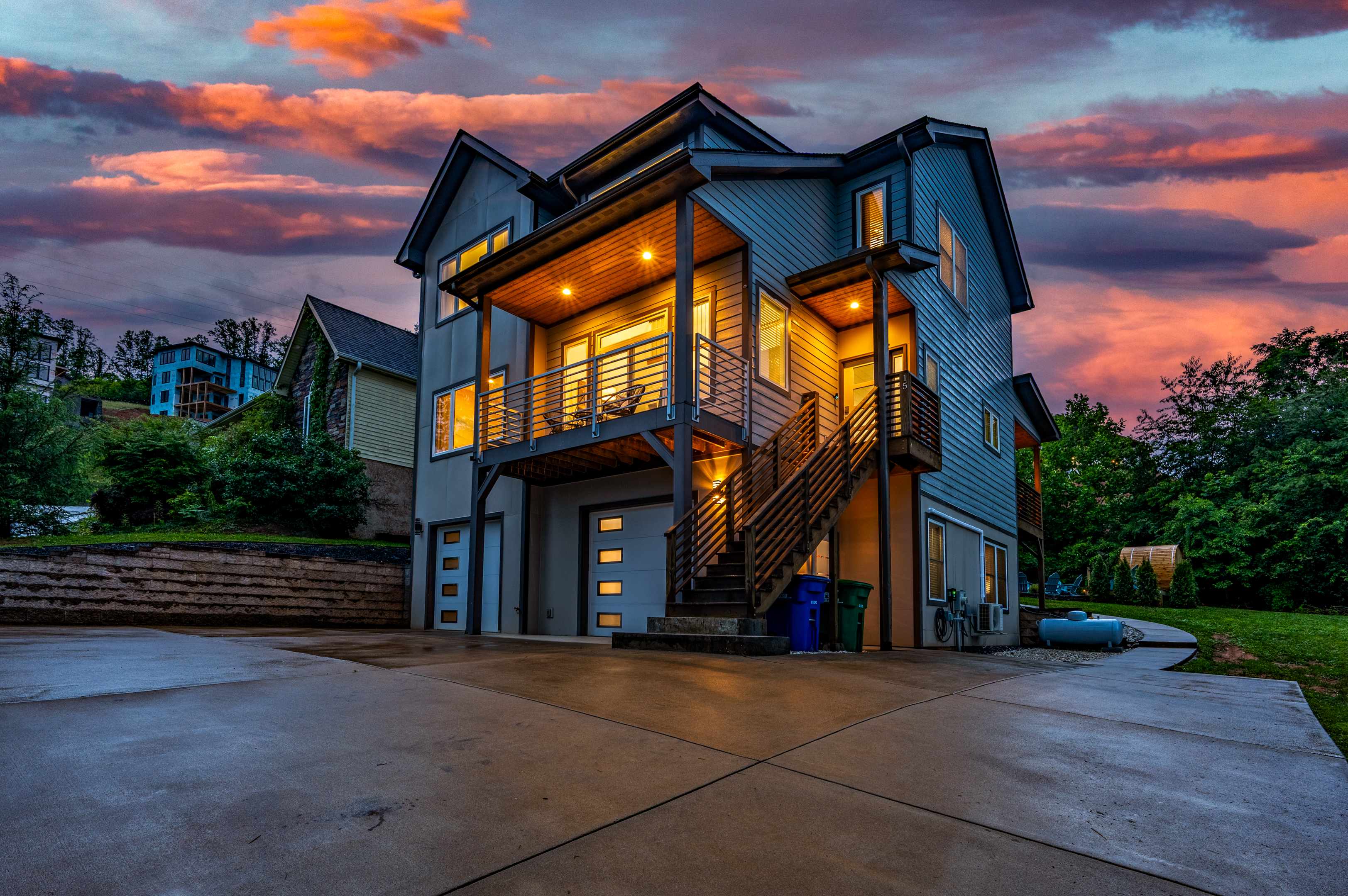 Ashe & Ember — modern mountain home glowing at sunset
