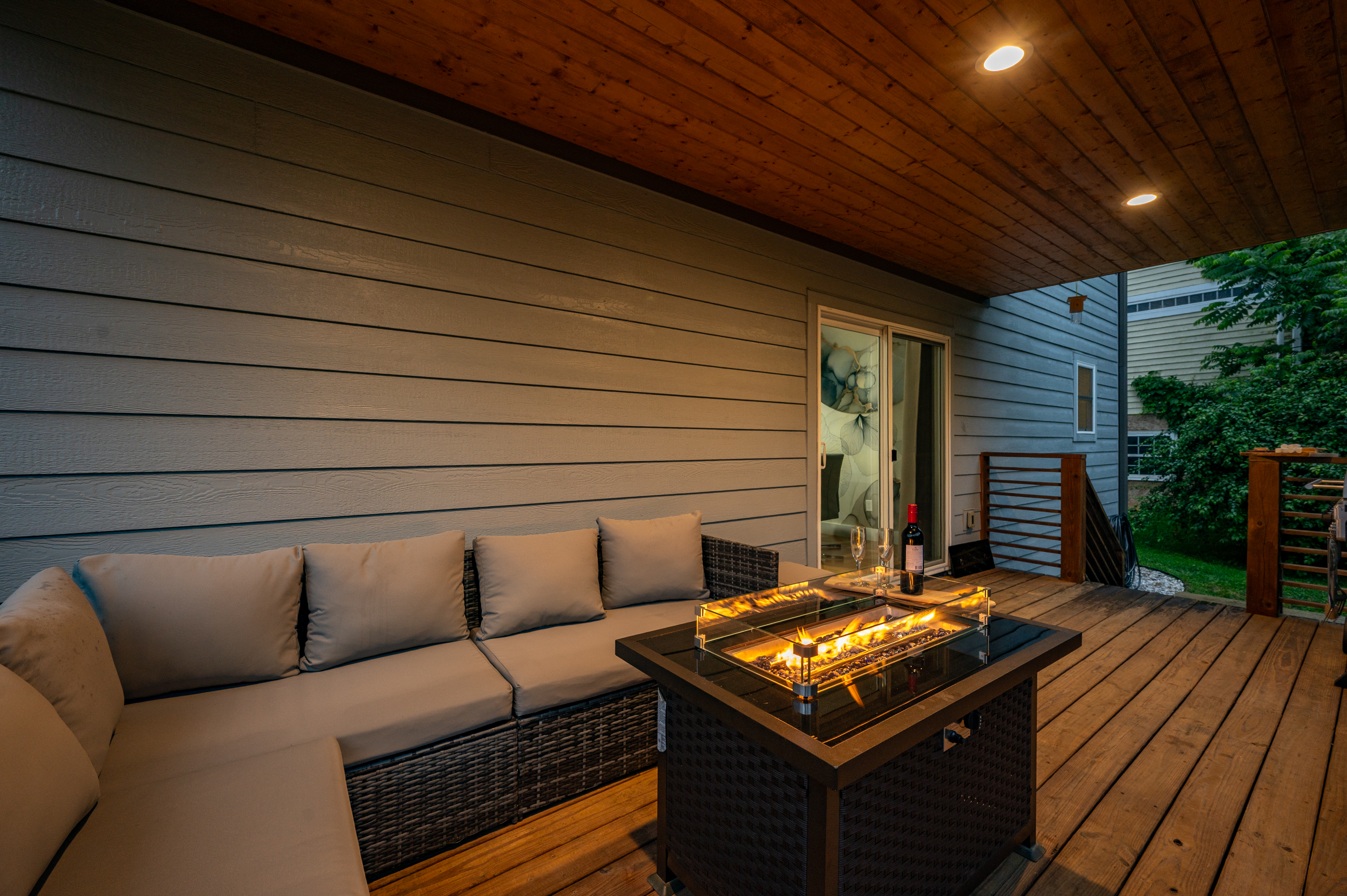 Covered deck with fire table and sectional seating