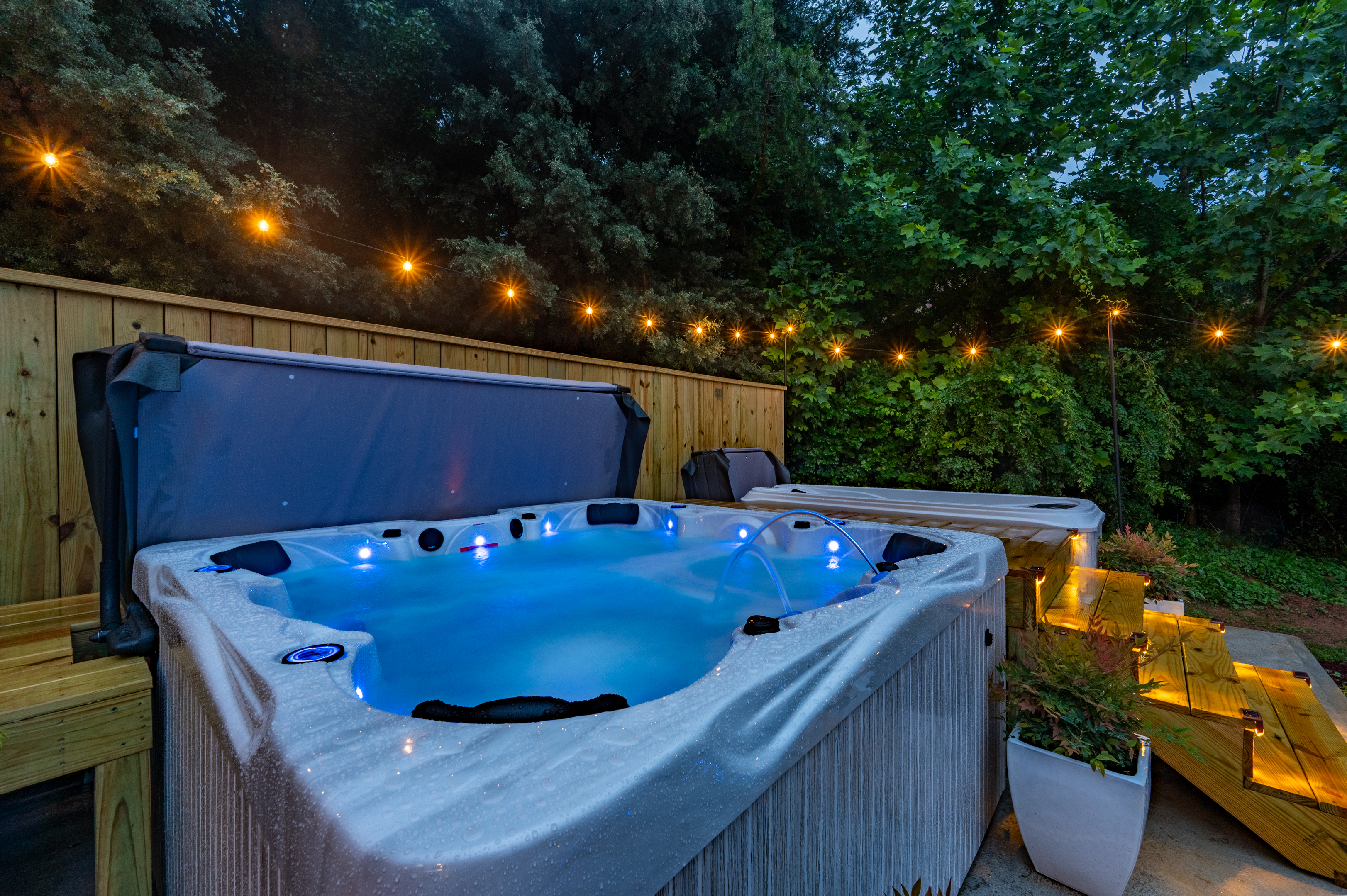 Private hot tub retreat with string lights