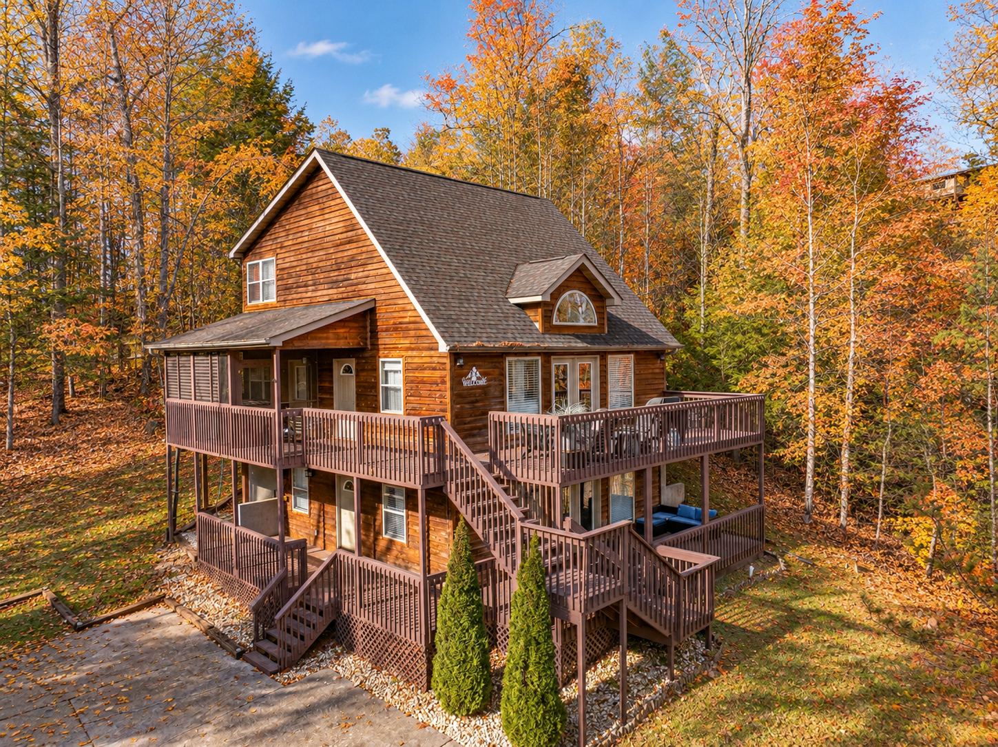 Rustic multi-level cabin with wraparound decks in stunning fall woods