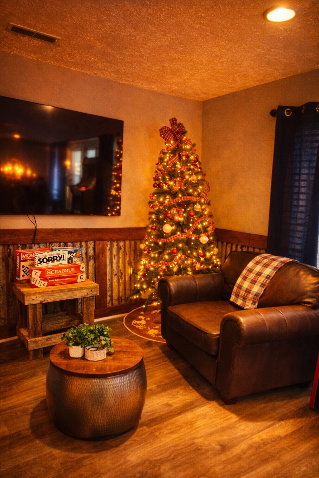 Cozy lounge with TV, games, and a festive holiday tree