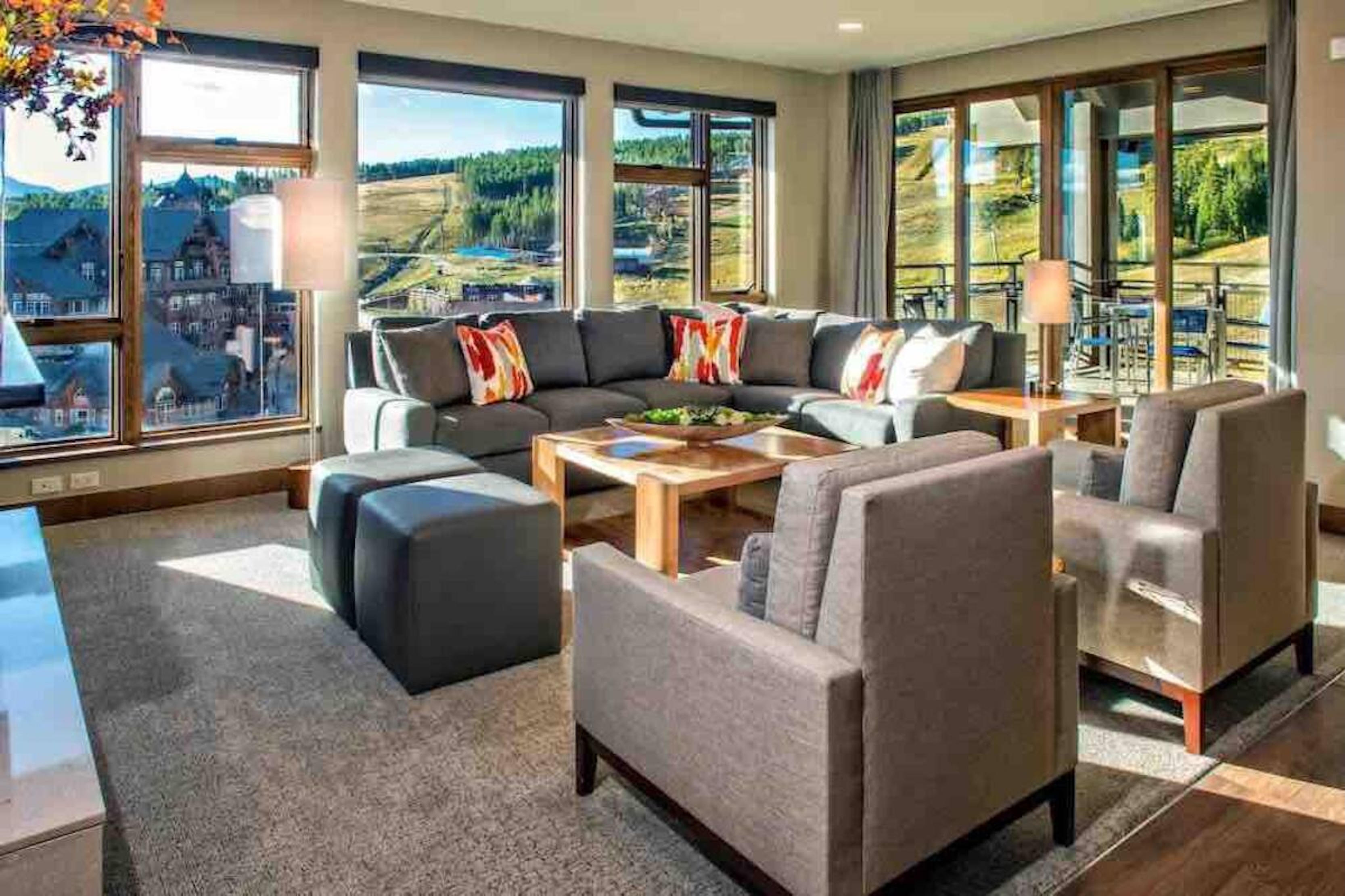 Sunlit mountain-view living room with spacious seating and large windows