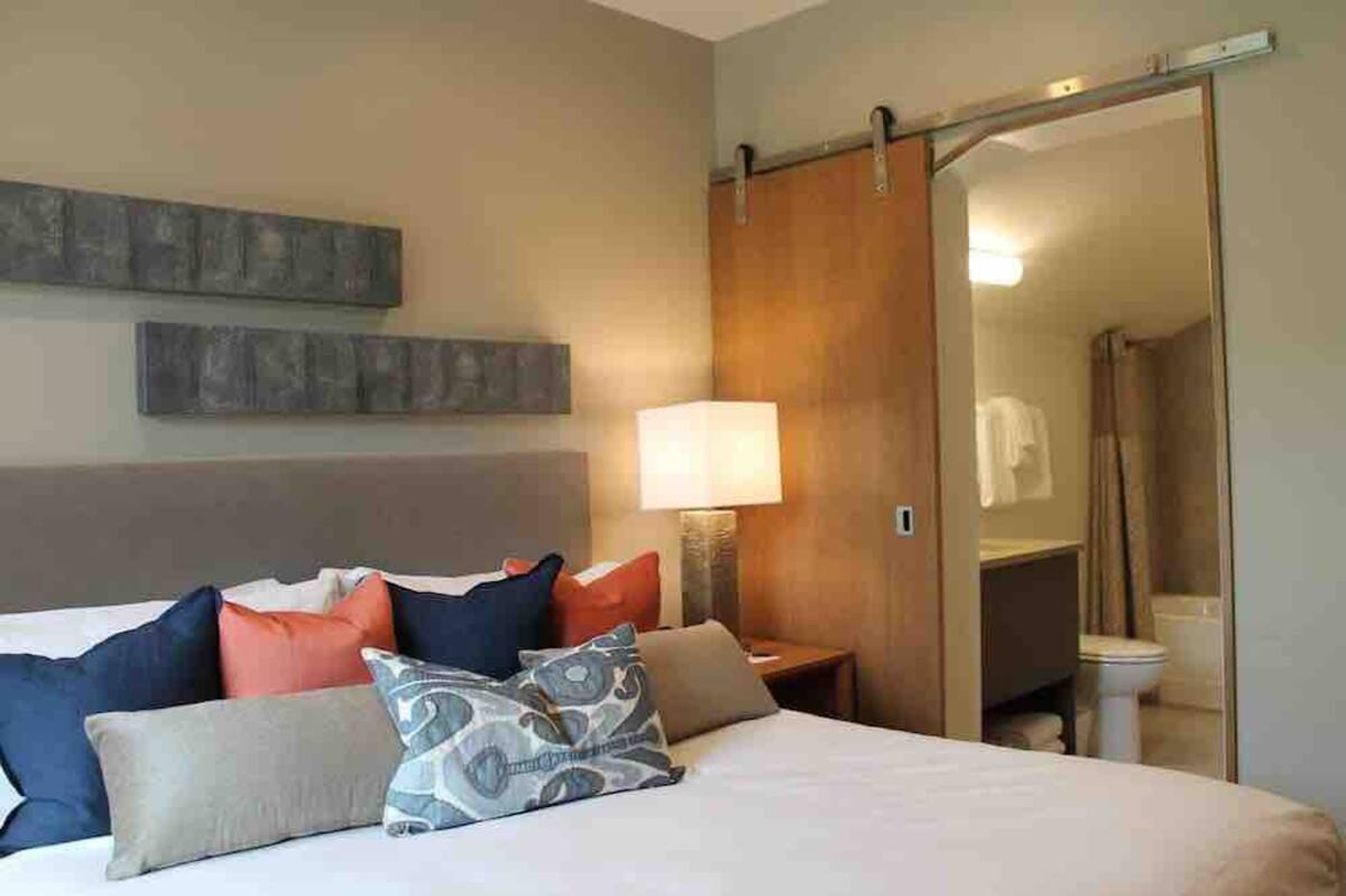 Cozy modern bedroom with plush bedding and private en suite bath
