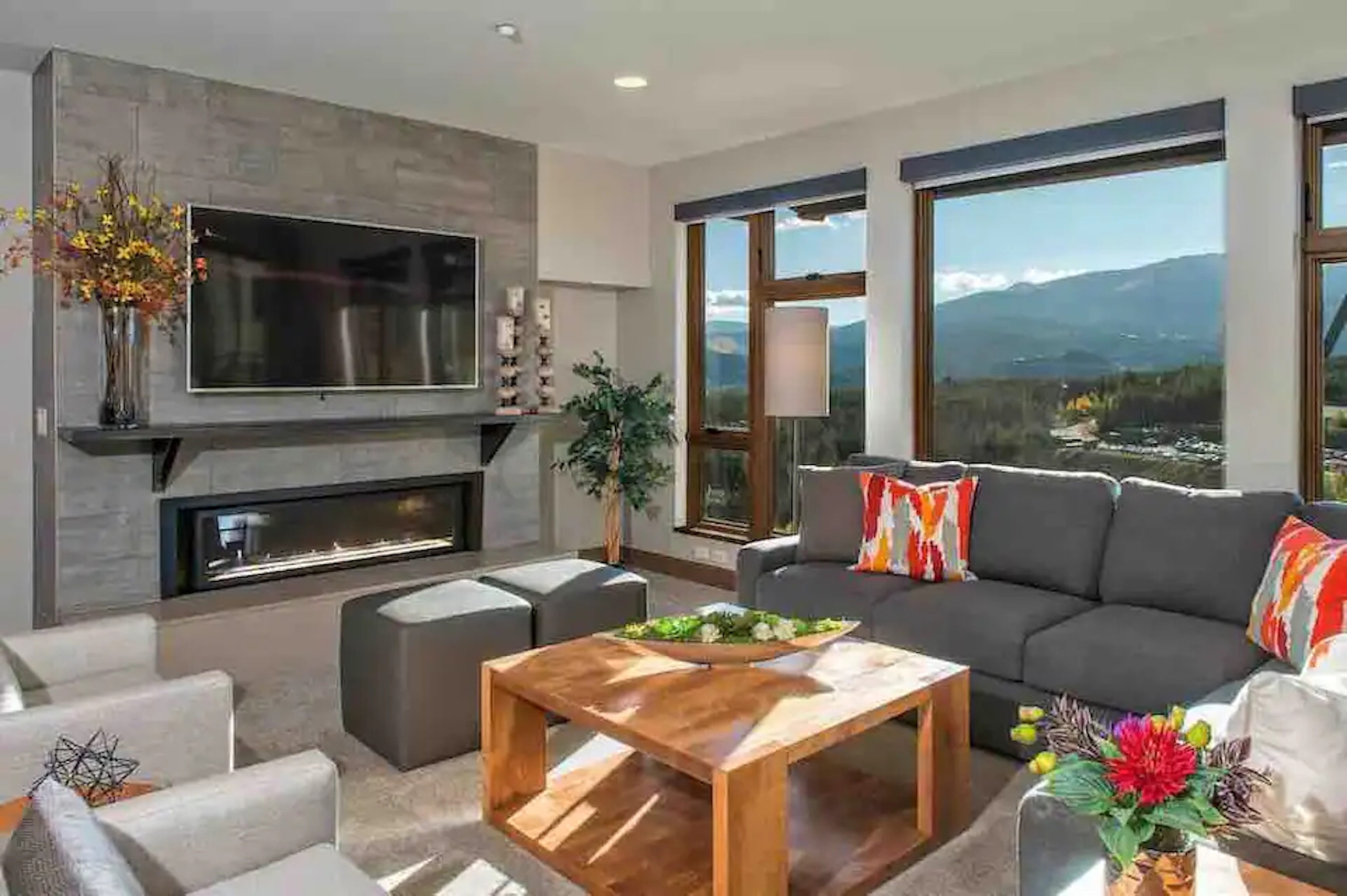 Modern living room with fireplace and stunning mountain-view windows