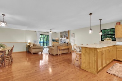 Unwind in the bright, open living space, where a large kitchen island invites easy gatherings and balcony access welcomes in fresh mountain air and sweeping views for the perfect retreat.