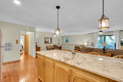Gather in the bright, open-concept kitchen and living area, where spacious island seating brings everyone together — the perfect hub for cooking, laughing, and making mountain memories.