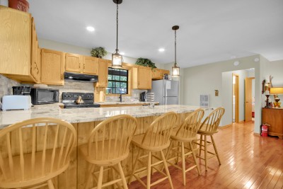 Cook up mountain favorites in the spacious kitchen, where a large island offers seating for five atop warm hardwood floors — the perfect gathering spot for meals, conversation, and connection.