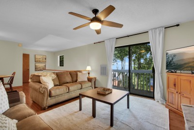 Unwind in the inviting living room, where a private balcony opens to serene, tree-filled views — the perfect spot to slow down, breathe in the mountain air, and savor peaceful moments.