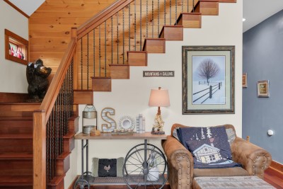 Warm wood details and rustic charm bring character to this mountain-style stair nook, adding one more thoughtful touch to your Hanging with My Gnomies stay.