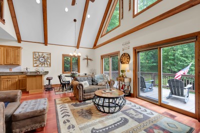 Take in forest views from this vaulted great room, where deck access invites you to step right outside and soak in the mountain scenery.