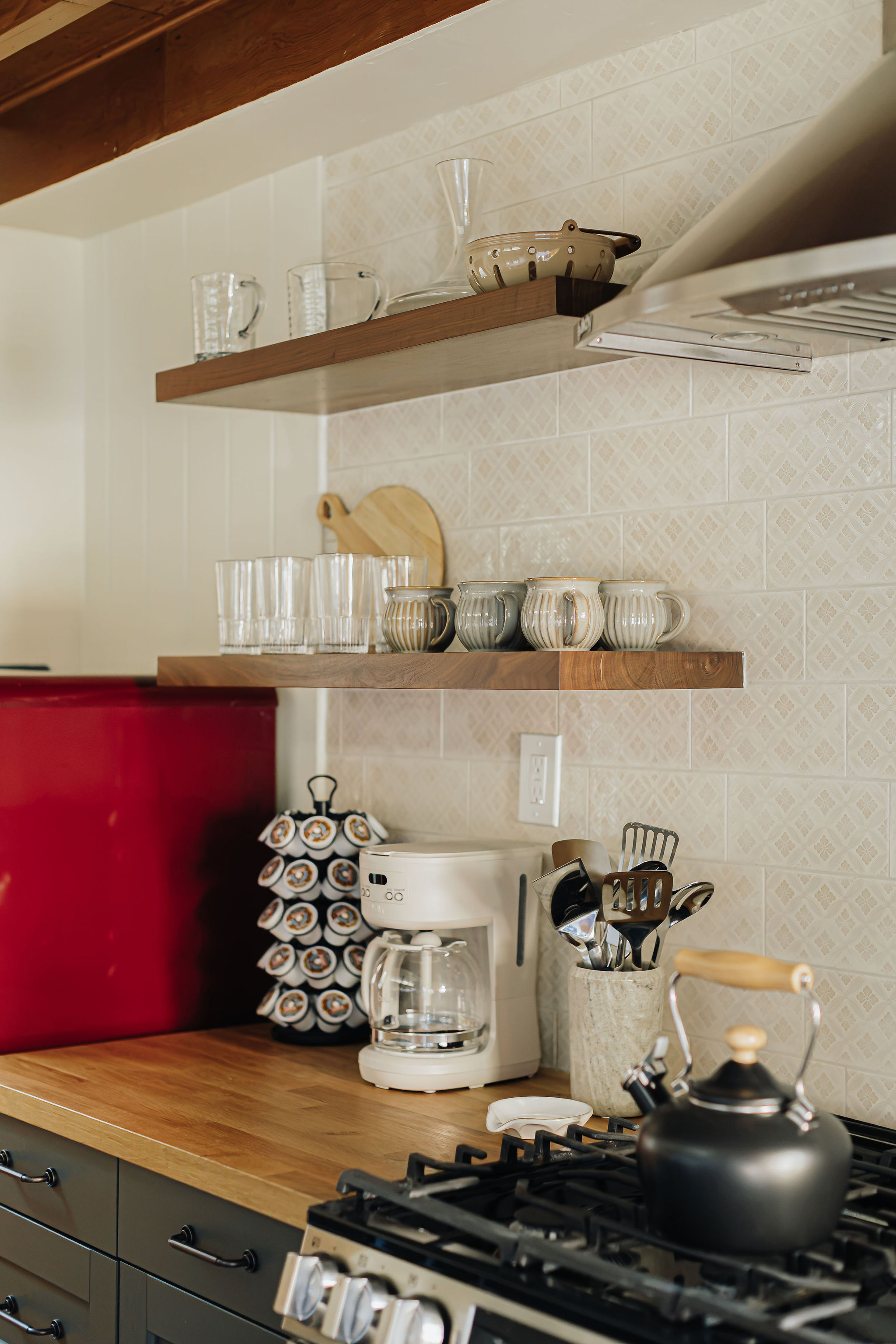 Chic kitchen nook with coffee station, gas range, and retro red fridge