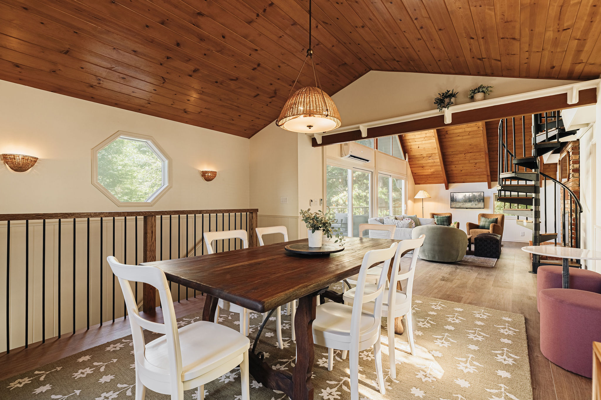 Warm open dining and living space with vaulted wood ceilings