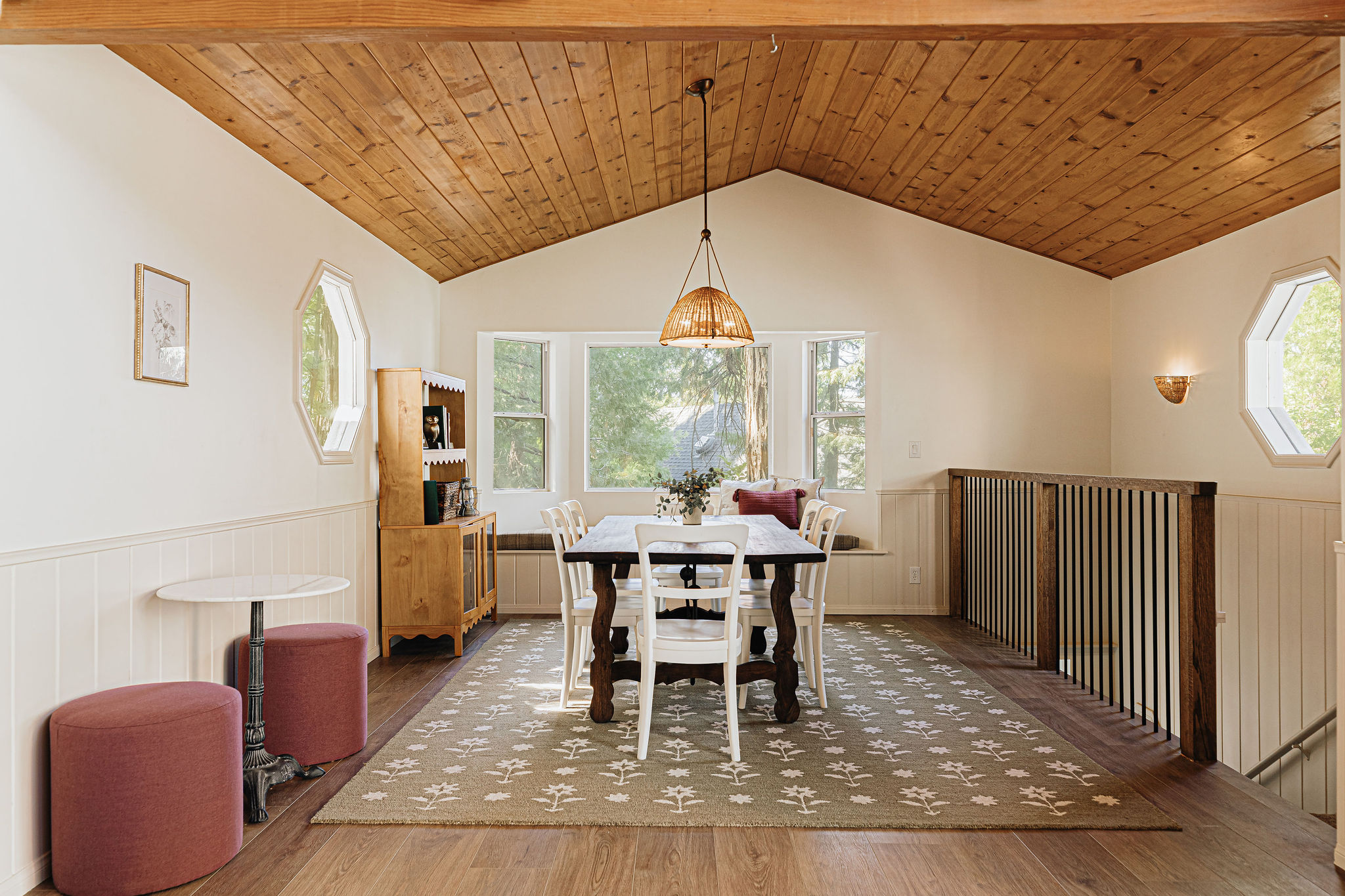 Bright dining loft with vaulted wood ceilings and serene treetop views