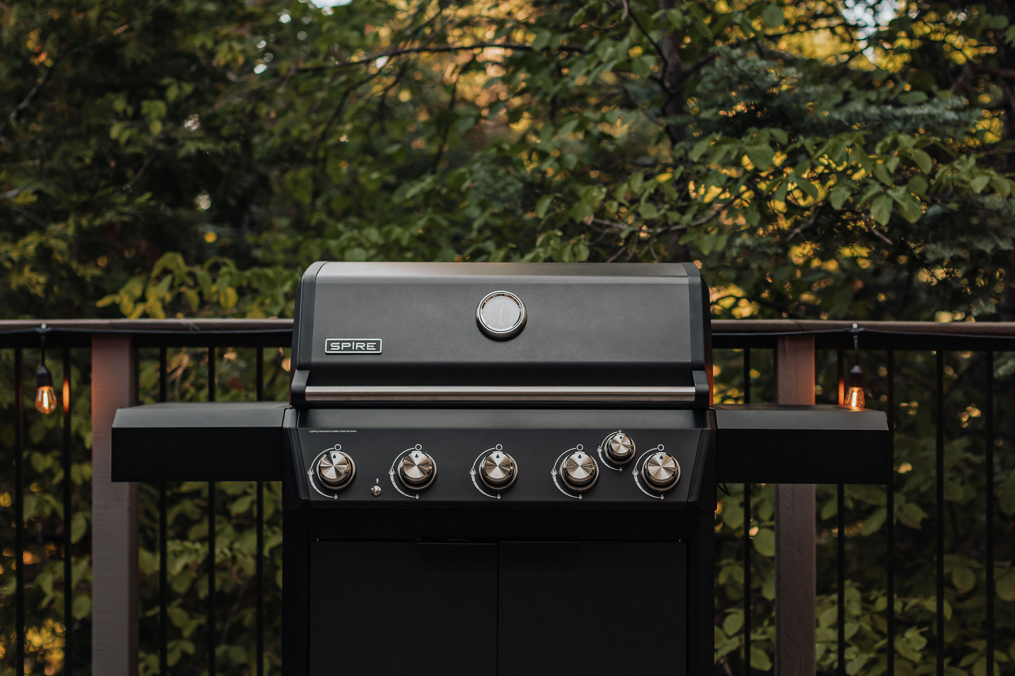 Private deck grill station surrounded by peaceful wooded views