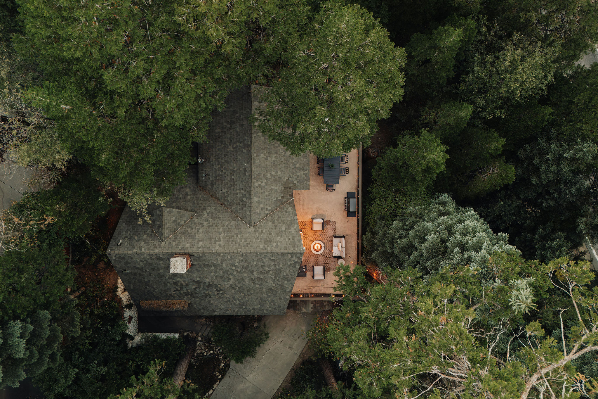 Secluded treetop retreat with spacious deck, lounge seating, and fire pit