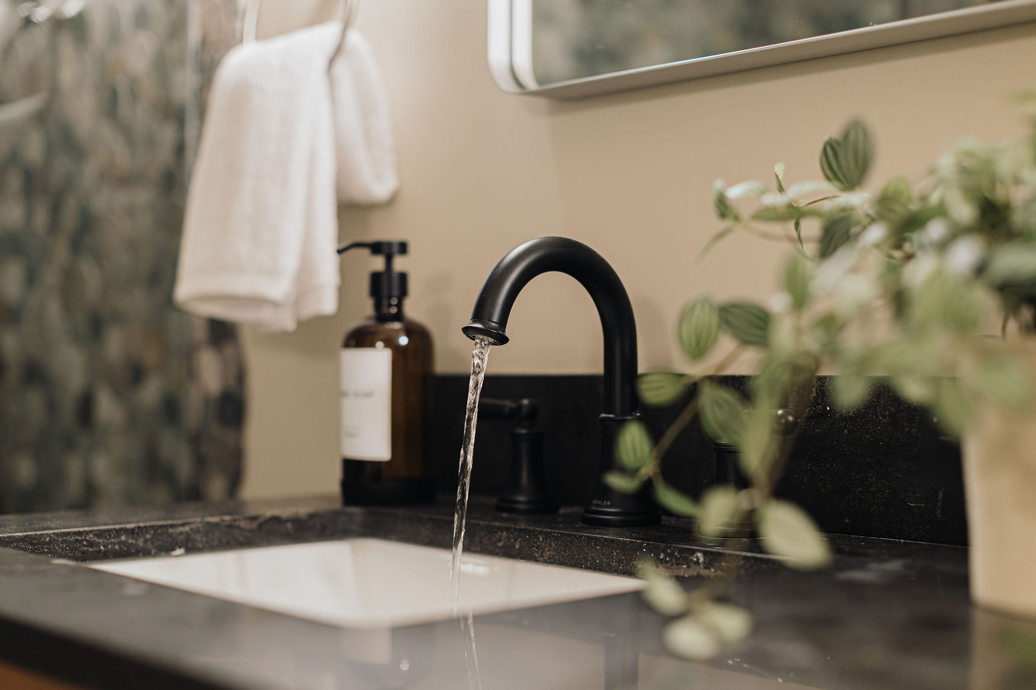 Spa-like bathroom with sleek black fixtures and modern finishes