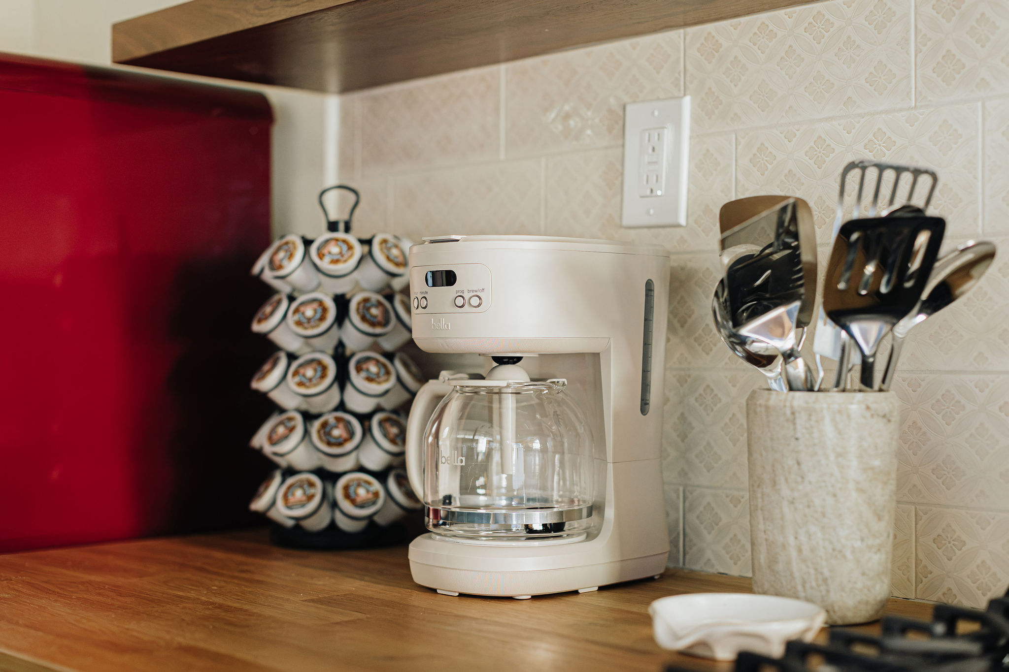 Well-stocked kitchen with coffee maker, pods, and handy cooking essentials