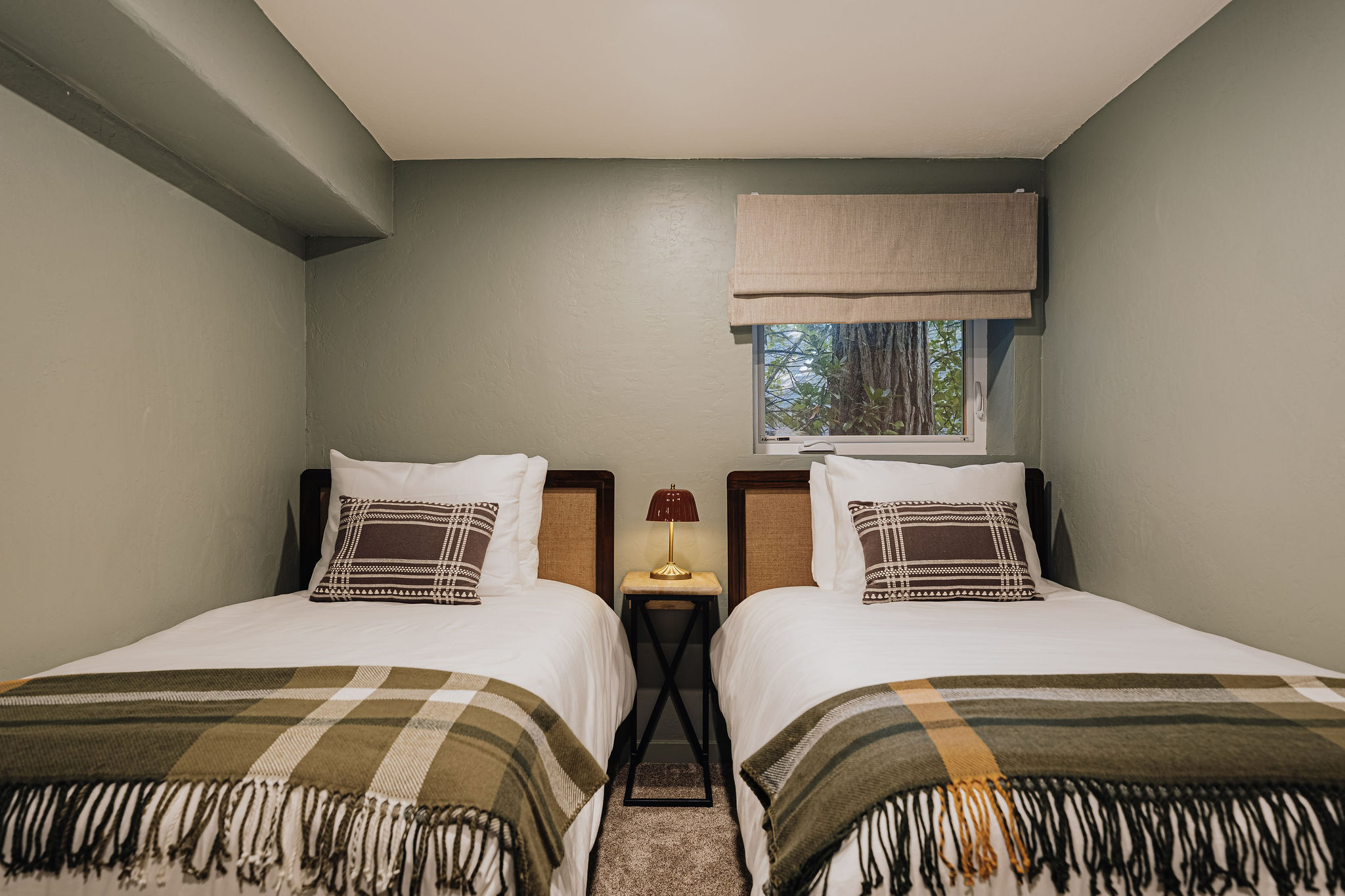 Cozy twin bedroom with warm textiles and peaceful natural light