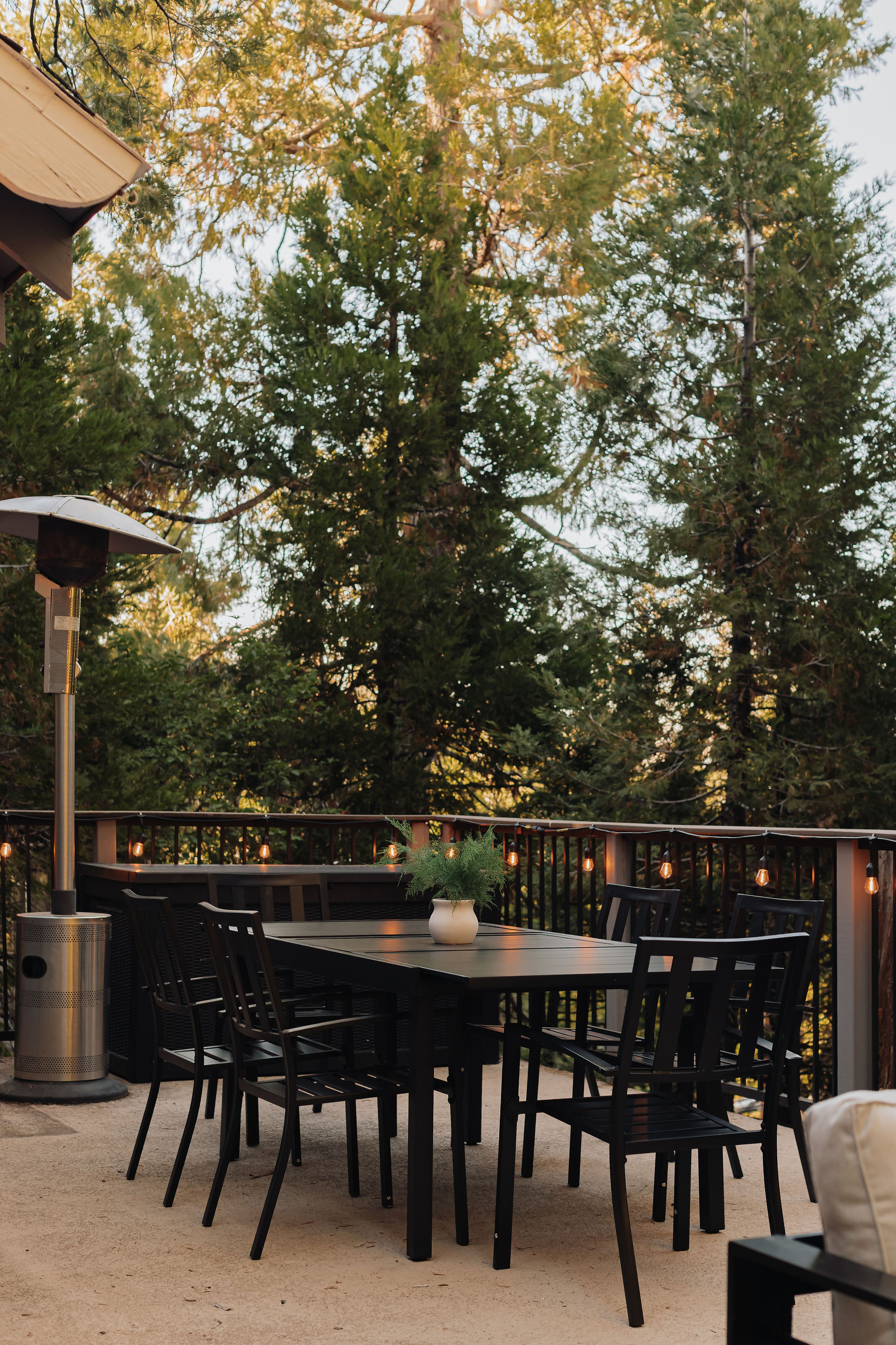 Private forest-view deck with outdoor dining, string lights & heater