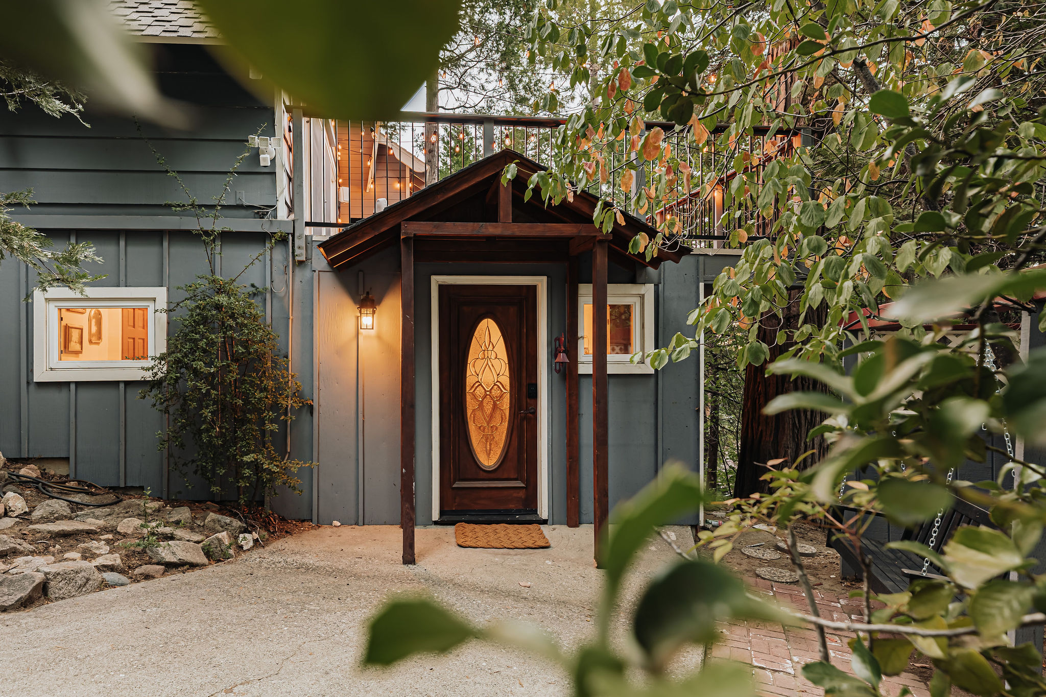 Charming private entry surrounded by trees and warm cabin-style details