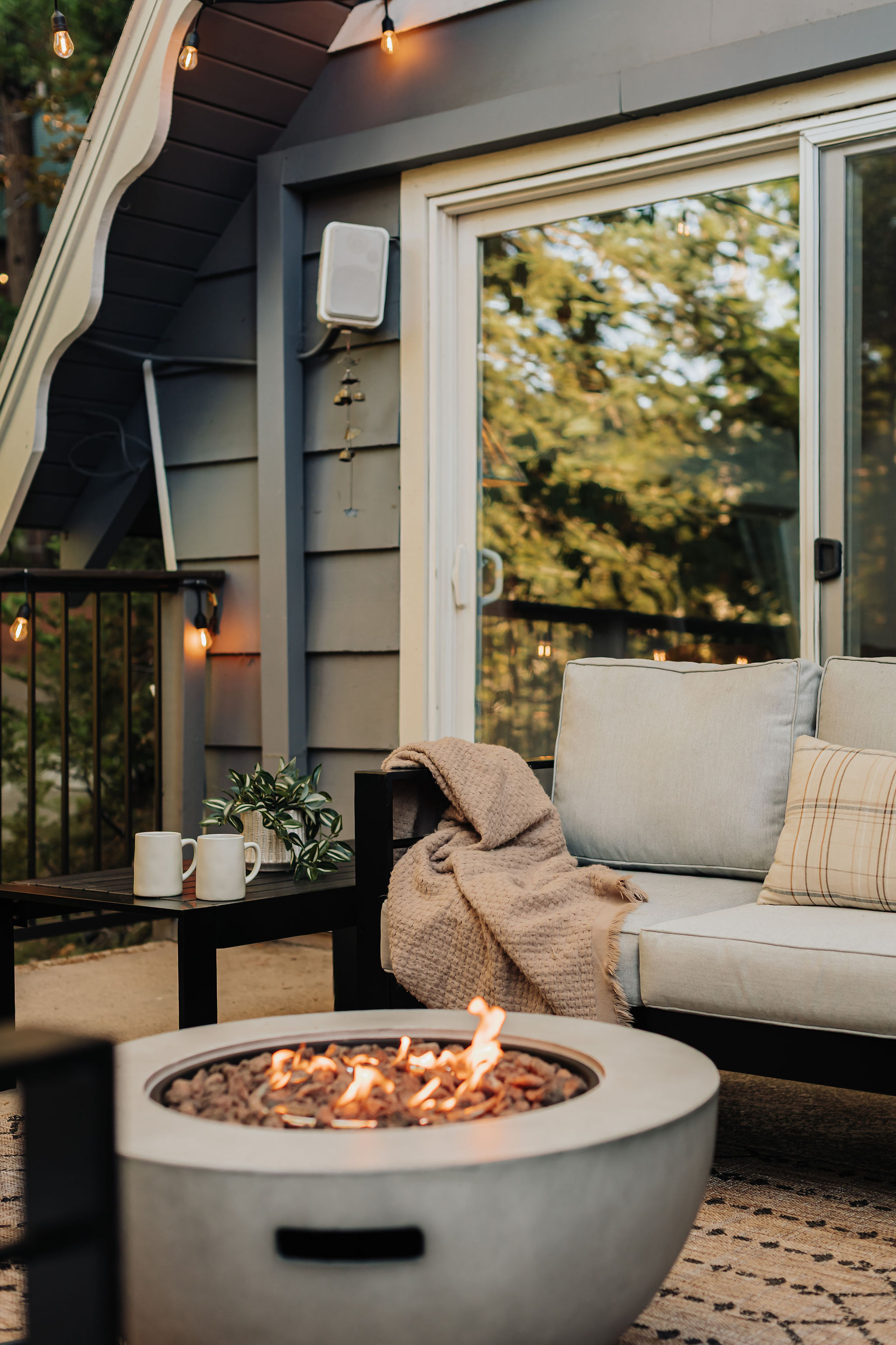 Cozy fire pit patio with cushioned seating and warm evening ambiance