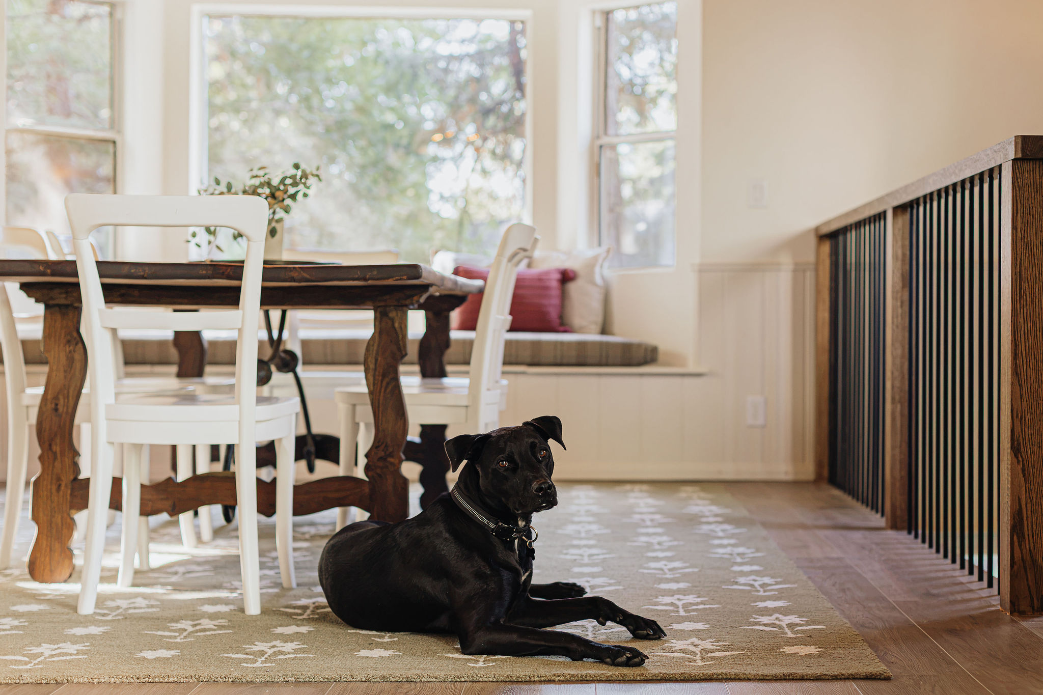 Sunny dining nook with rustic table and cozy window bench seating