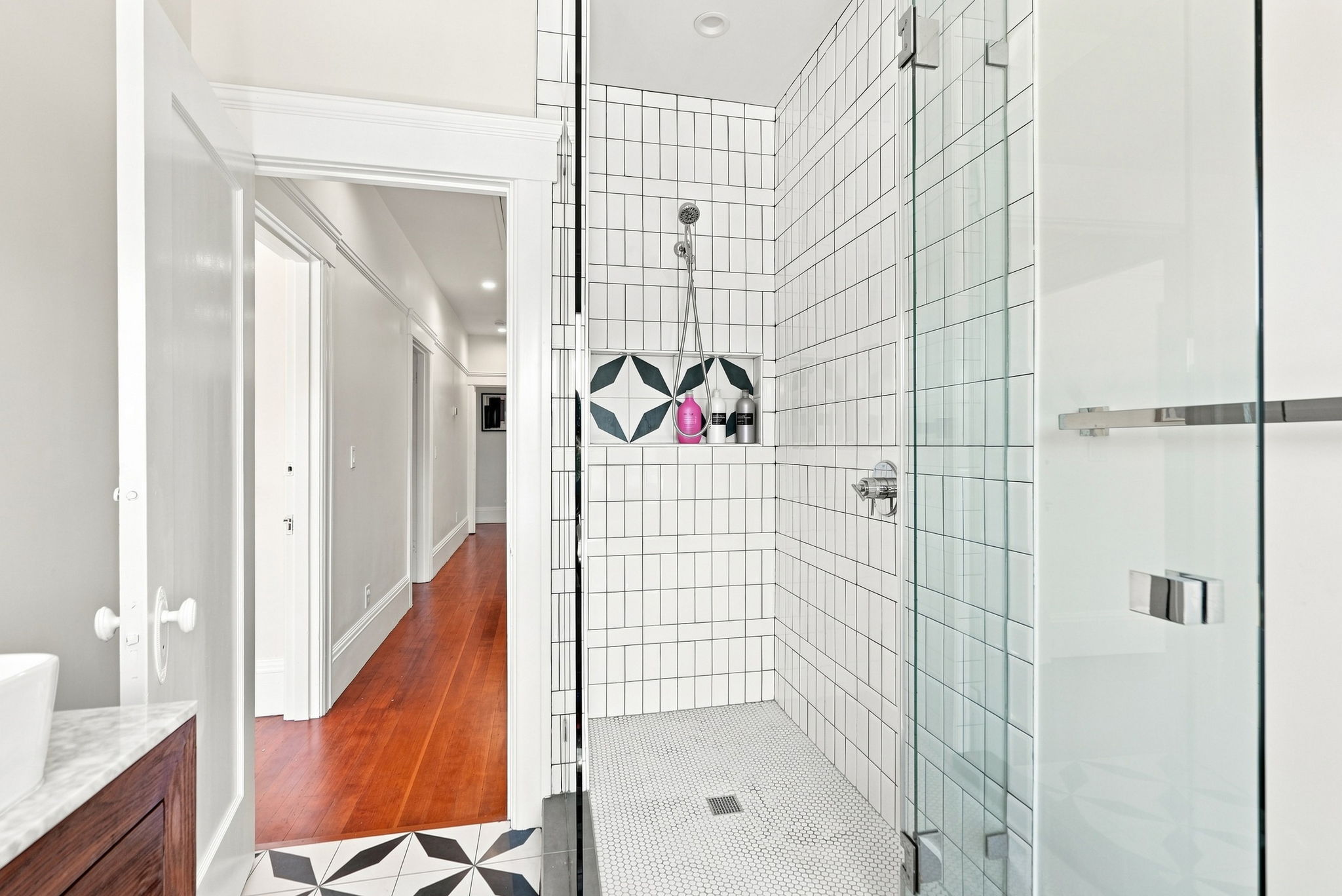 Bright modern bathroom with sleek walk-in glass shower and stylish tile