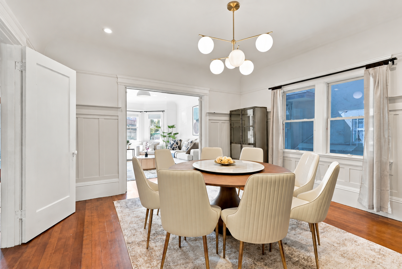 Bright formal dining room with seating for six and stylish modern lighting