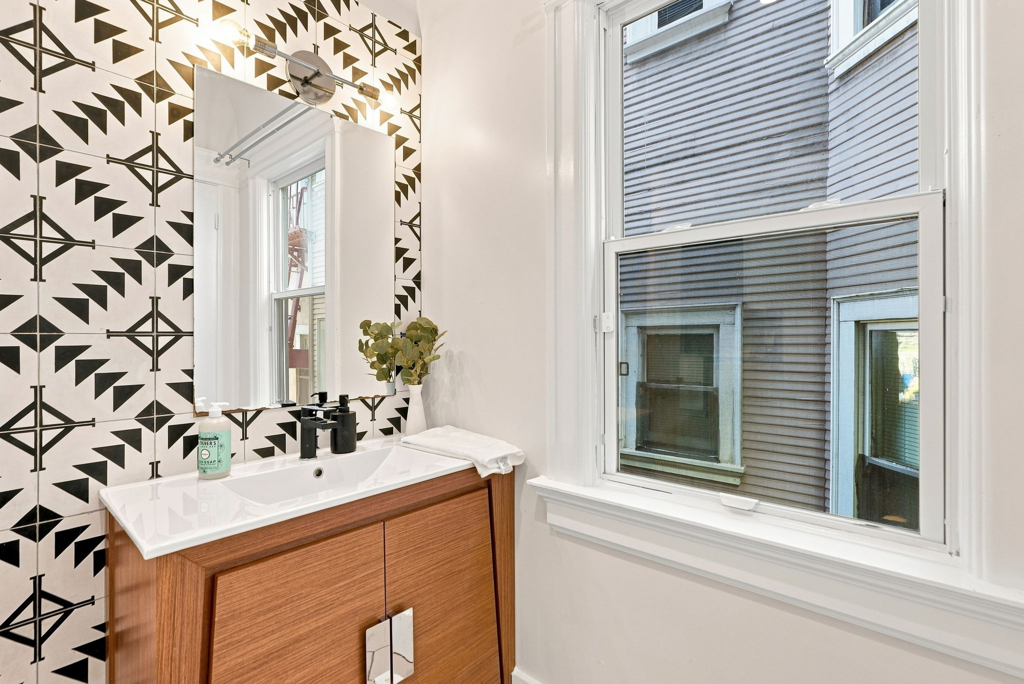 Bright modern bathroom with bold tile and natural light