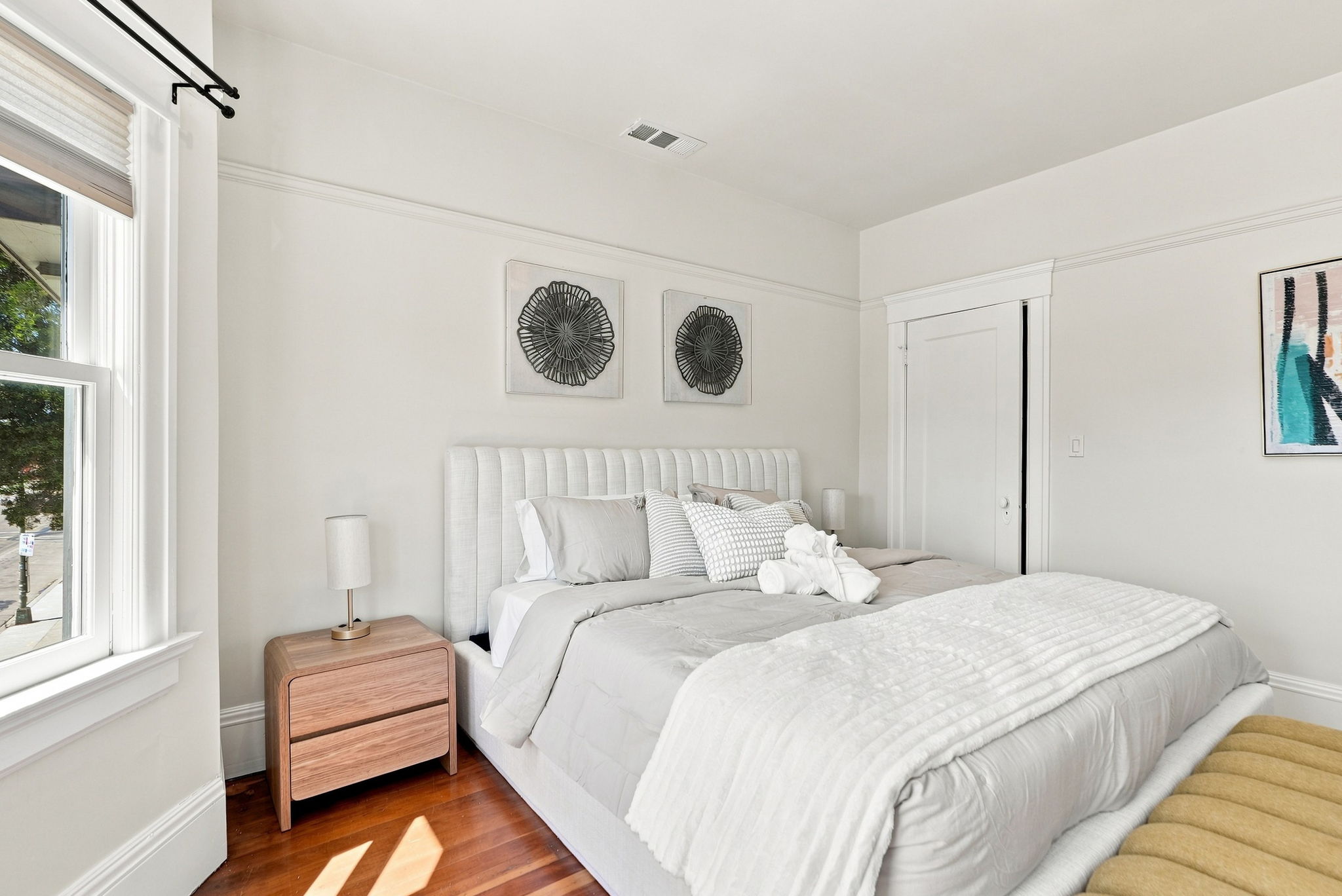 Bright, elegant bedroom with plush linens and beautiful natural light