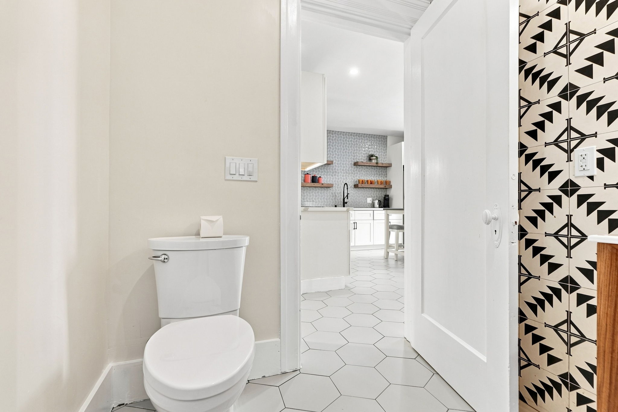 Bright half bath with modern tile and bold designer accent wall