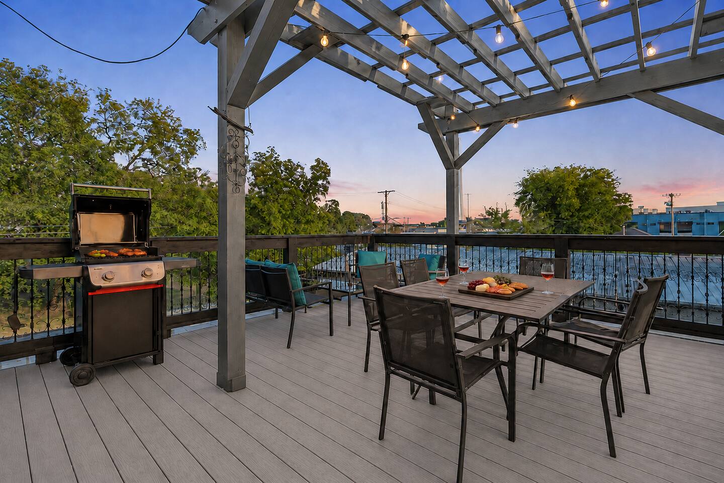 Dine alfresco beneath the pergola and string lights while enjoying a freshly grilled meal and sunset views.