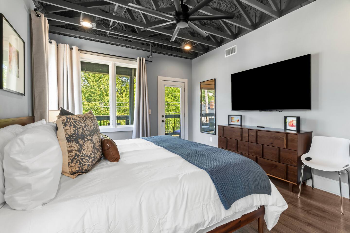 Bright modern king bedroom with ensuite and stylish industrial details
