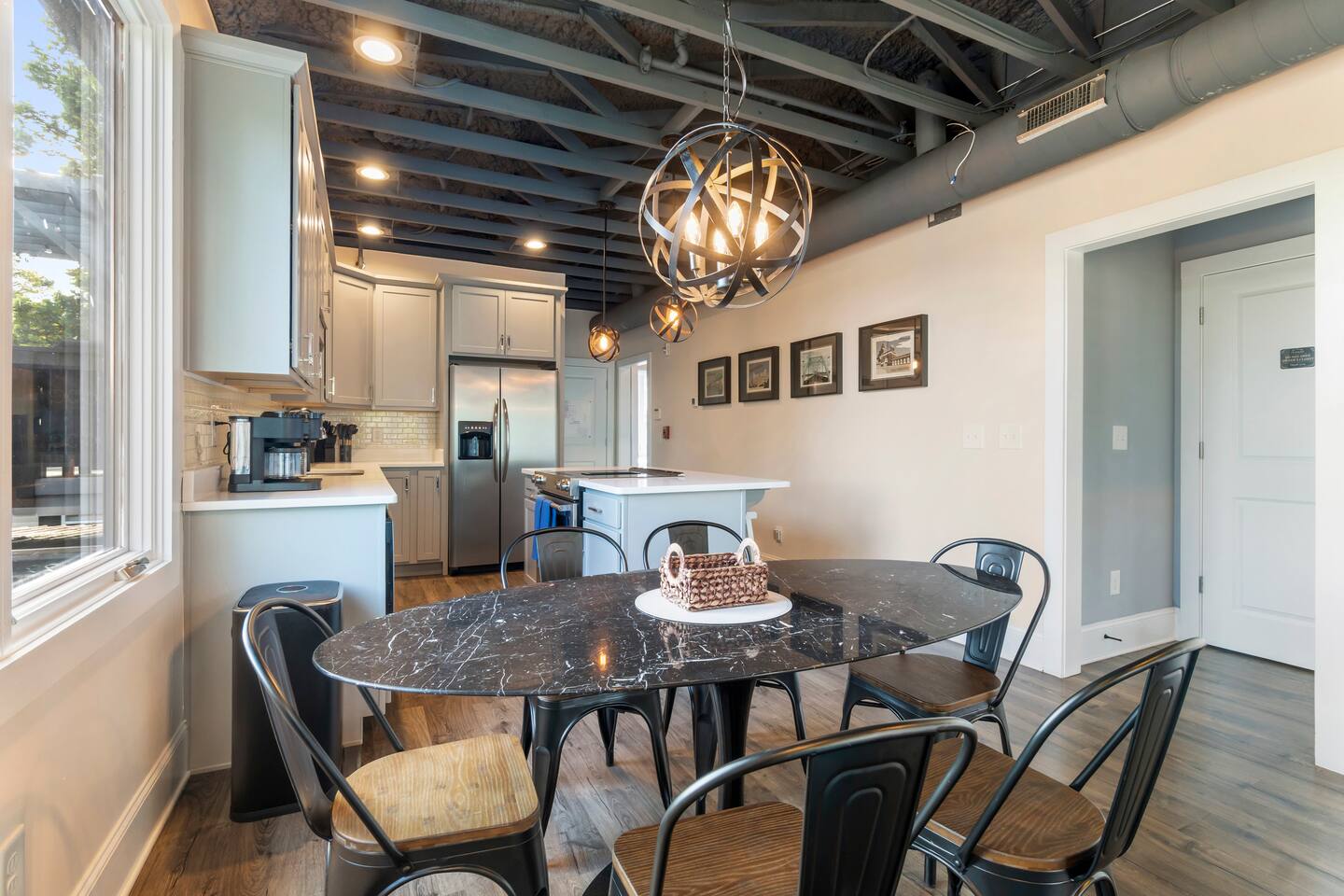 Sunny open living-dining space with large windows and stylish modern design