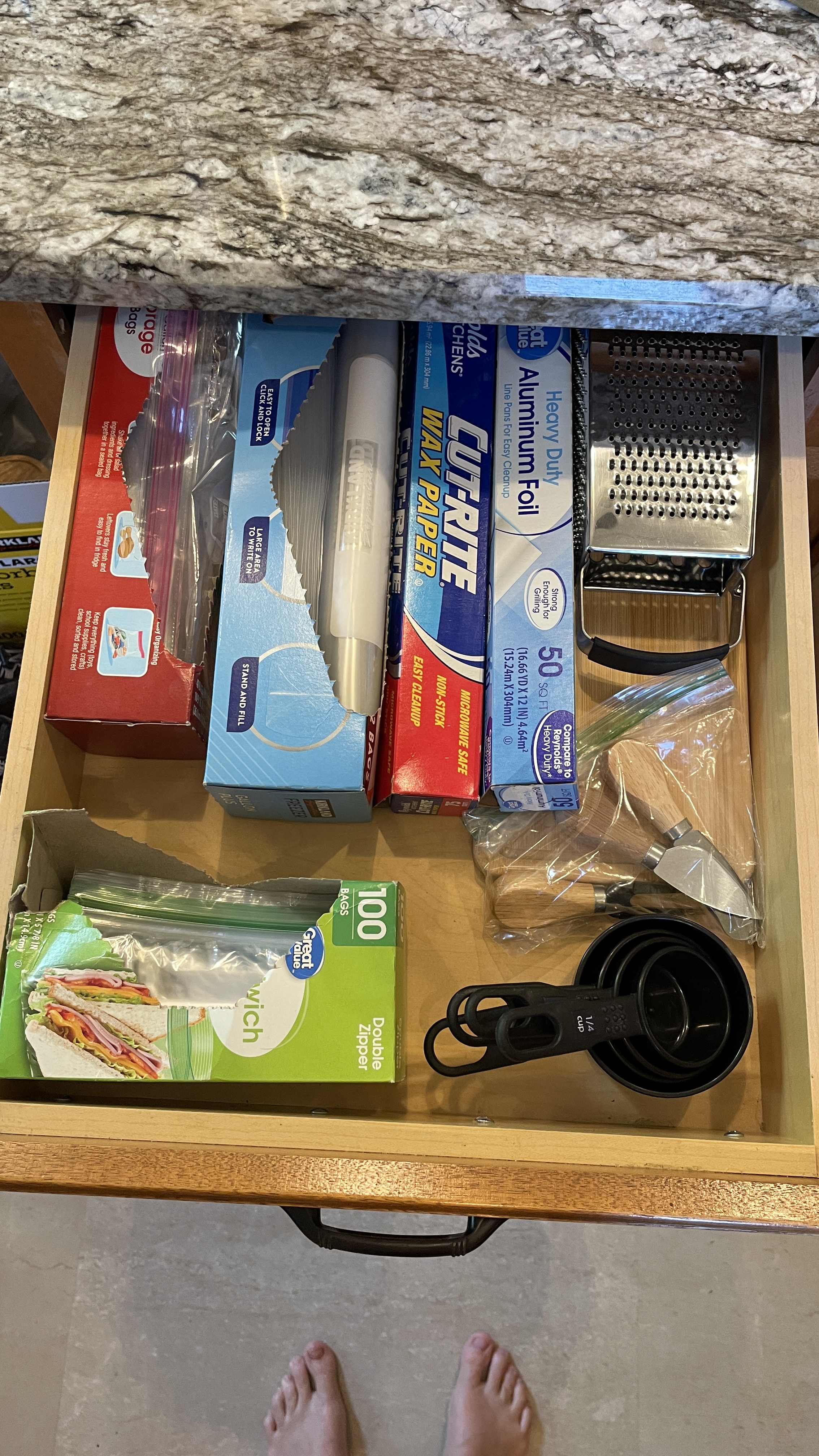 Fully stocked kitchen drawer with prep essentials for easy guest cooking