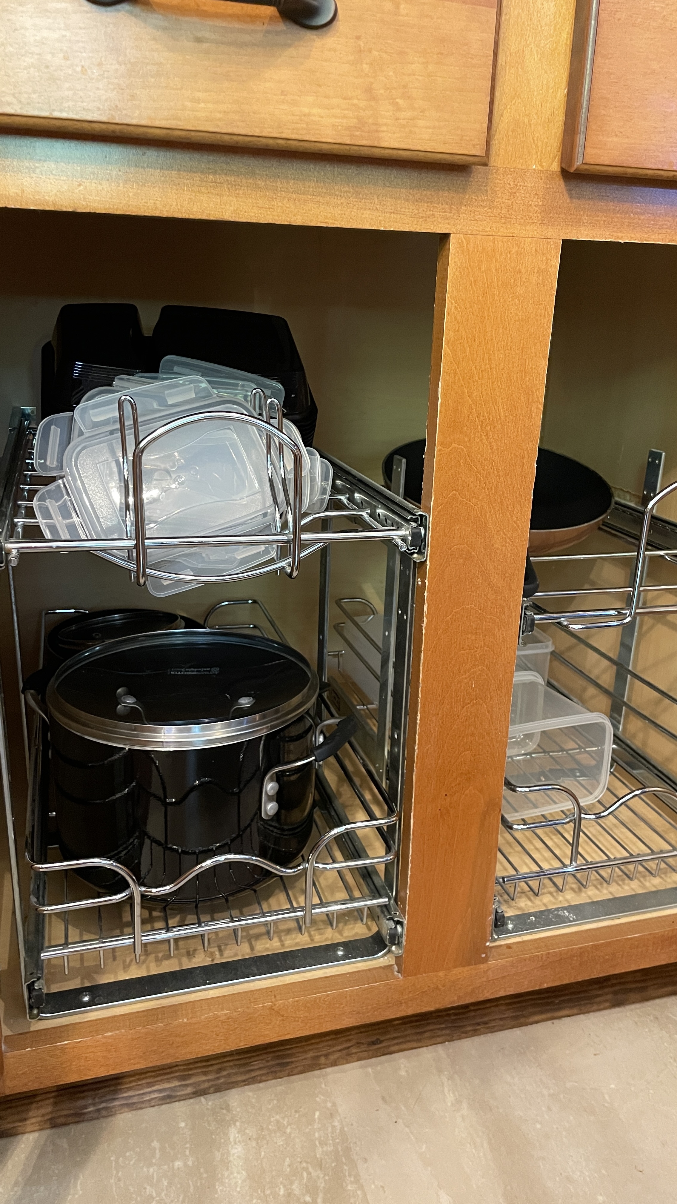 Well-stocked kitchen storage with pull-out racks and handy cookware