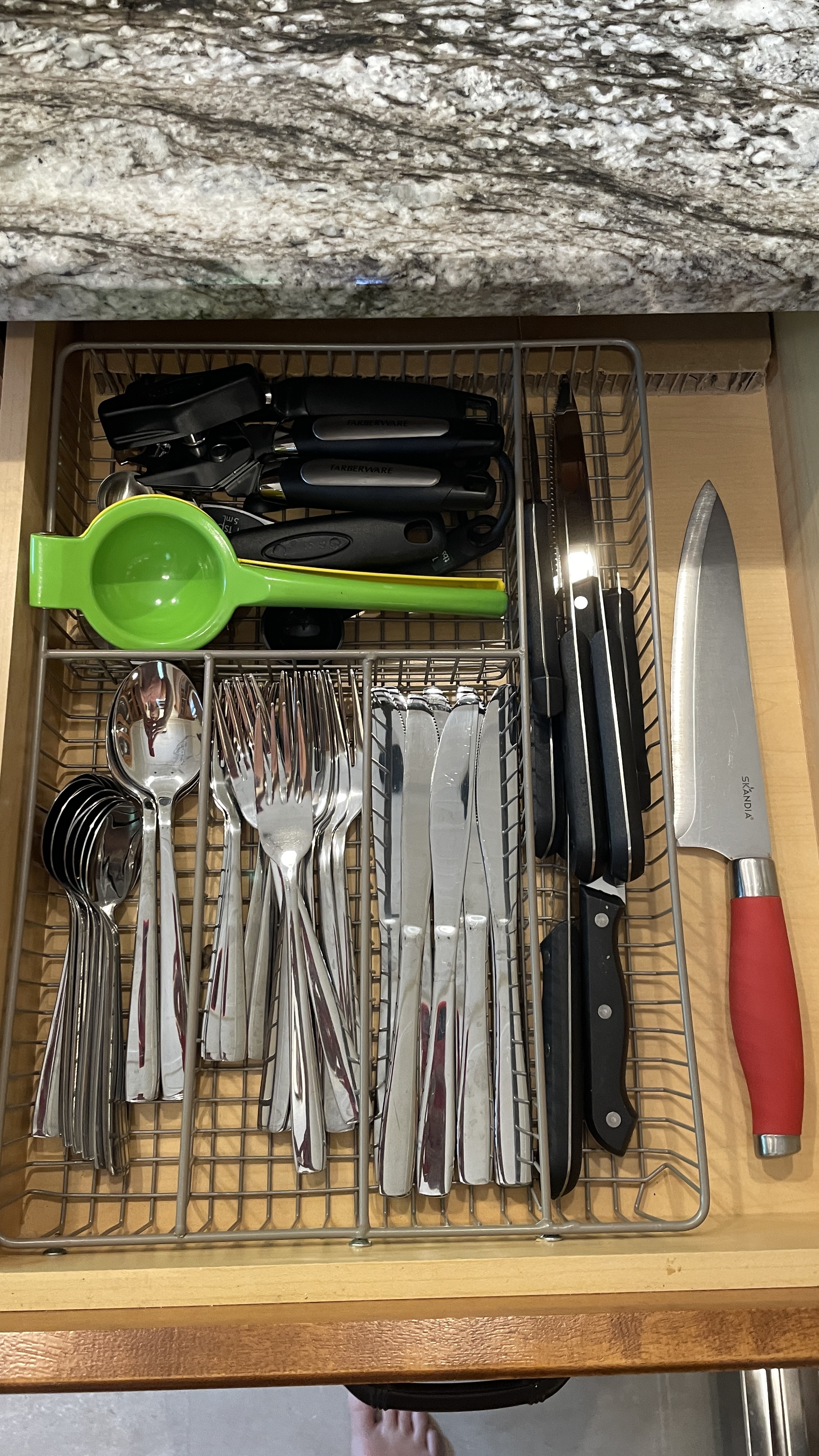 Well-stocked kitchen drawer with cutlery, tools, and prep essentials