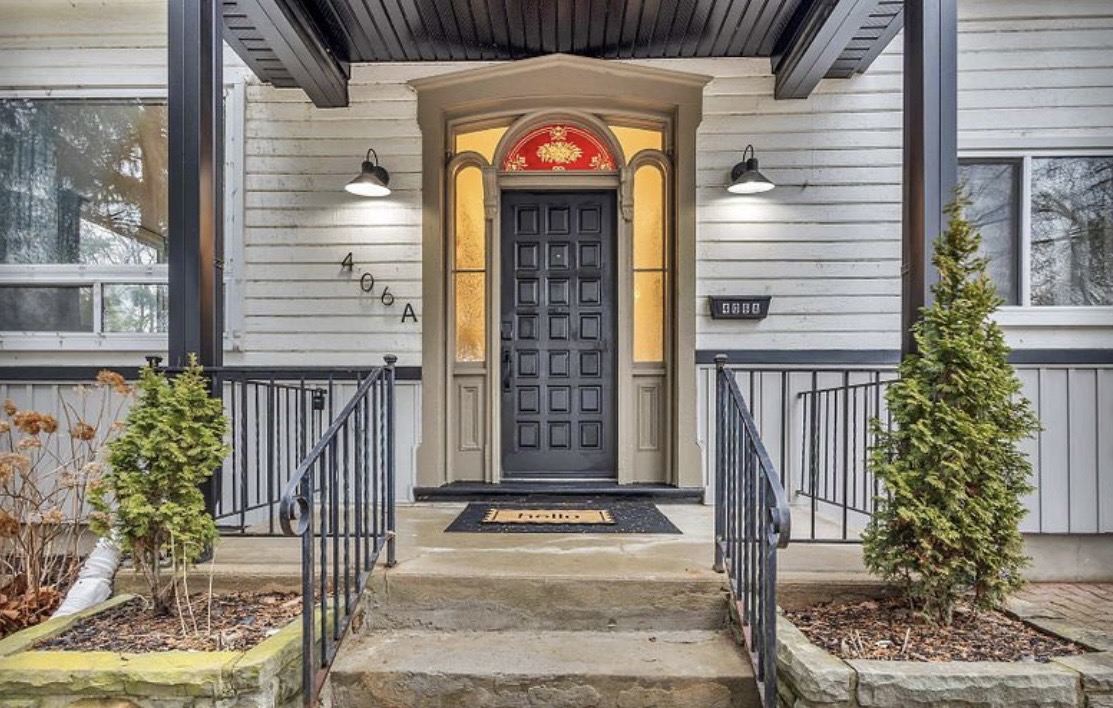 Elegant covered entry with charming curb appeal and stylish lighting