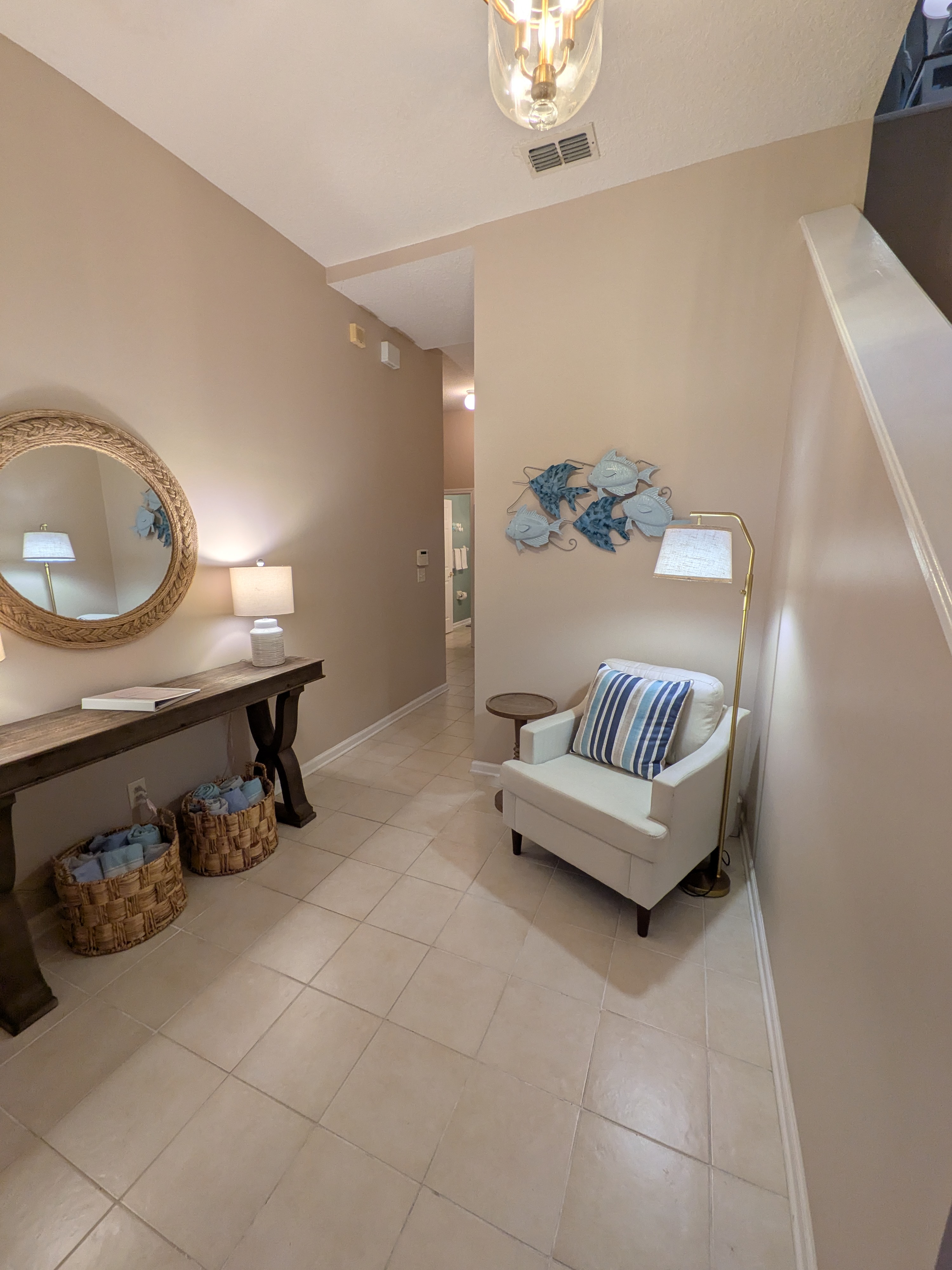 Bright coastal-inspired entry with cozy seating and elegant décor